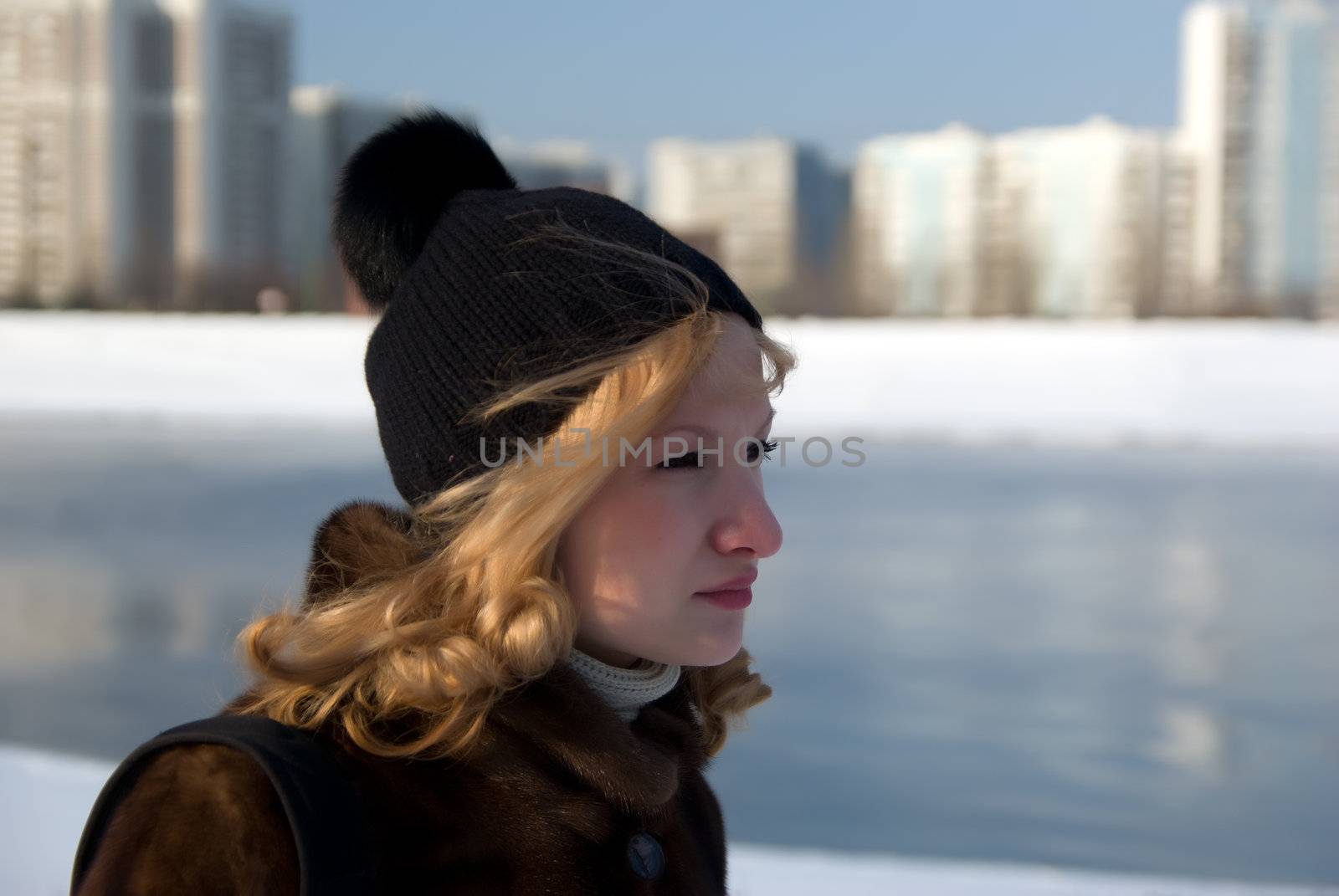 Portrait of the girl of the river walking on coast in the winter