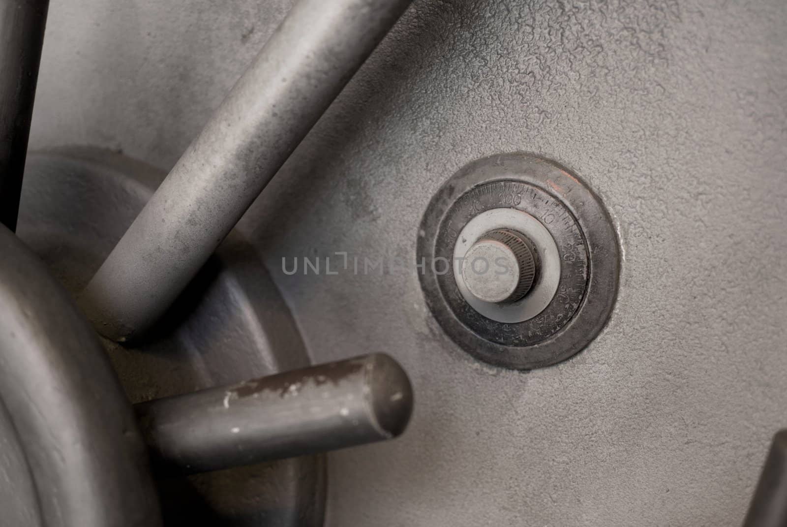 Gray old and worn safe door with grungy dial