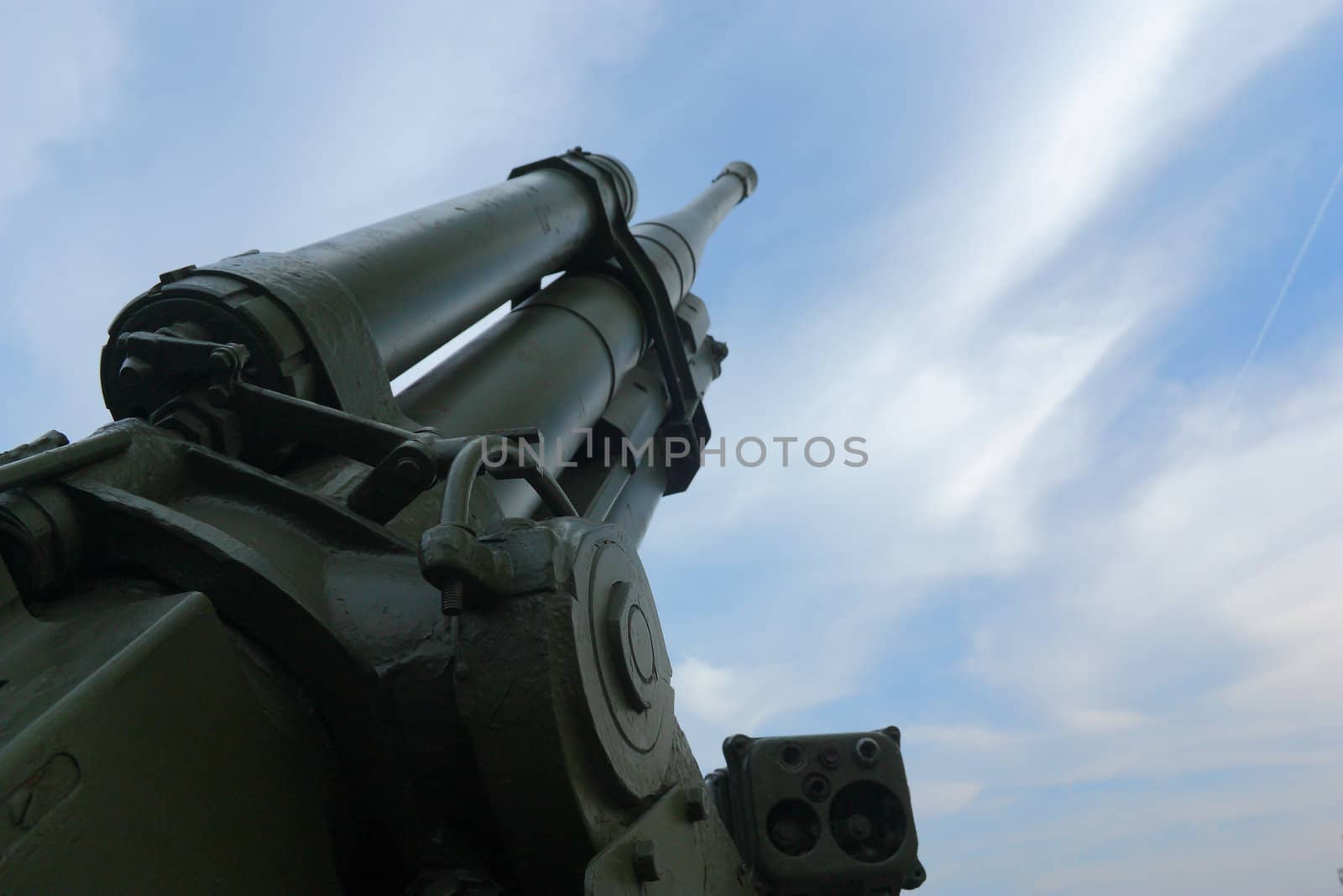Old Antiaircraft gun on a background of blue sky