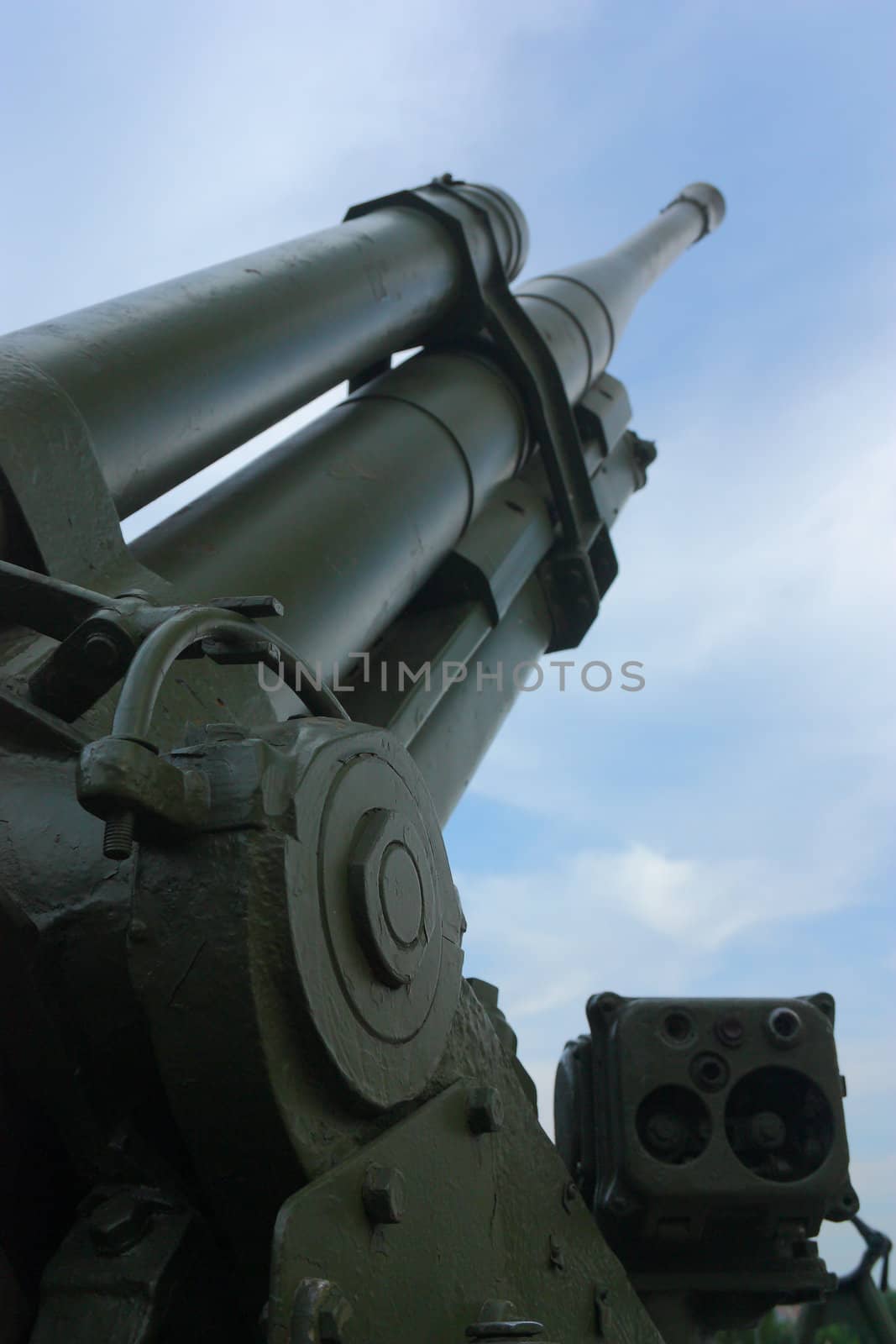 Old Antiaircraft gun on a background of blue sky