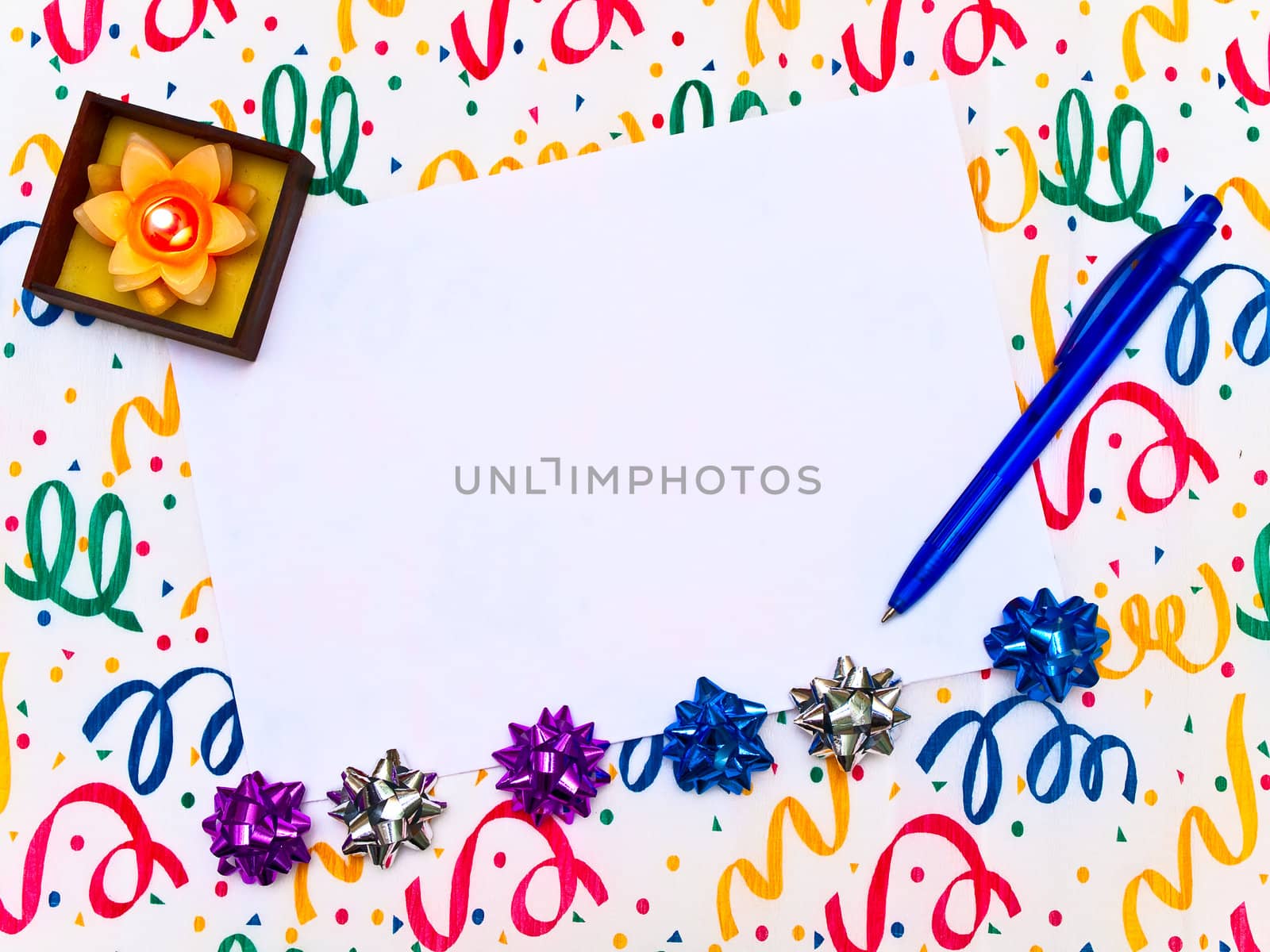blank invitation to the party with pen and burning candle 
