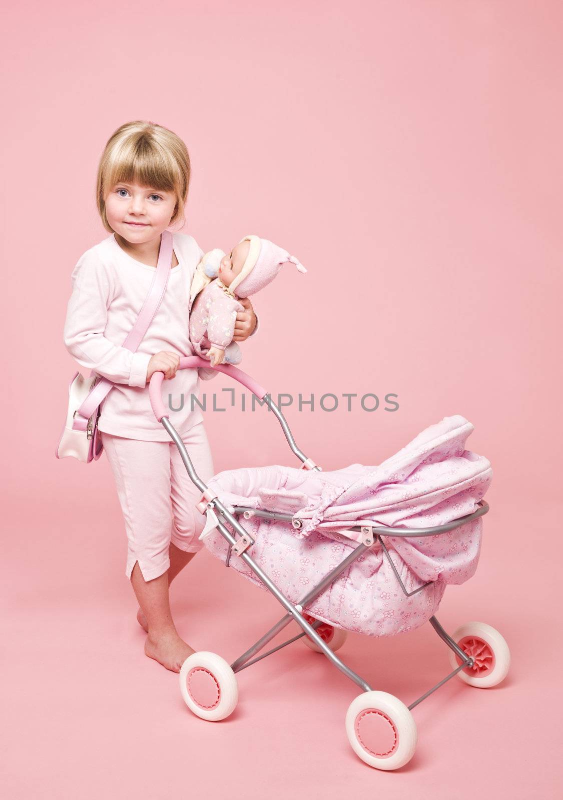 Young girl with Baby Stroller on pink background