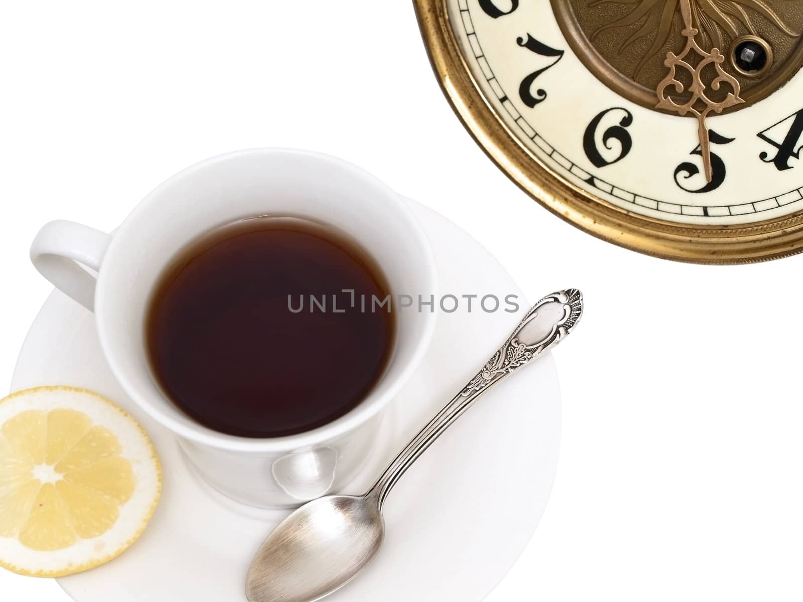 white cup of tea with lemon and spoon in it