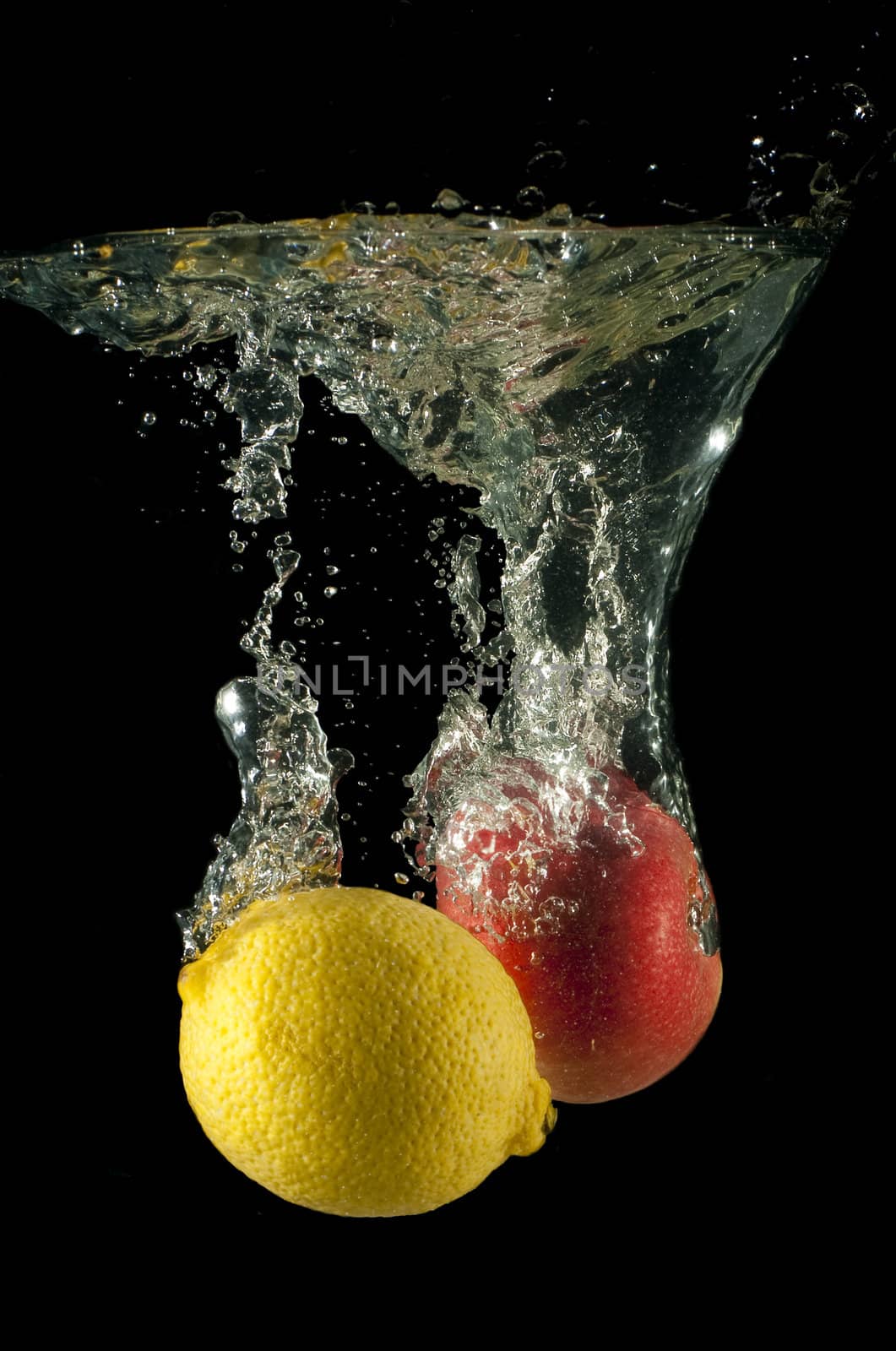 Lemon and apple fall in water