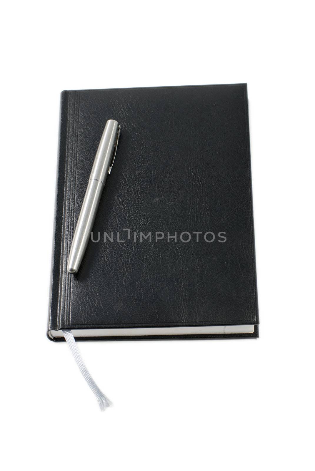 Pen and notebook on white background