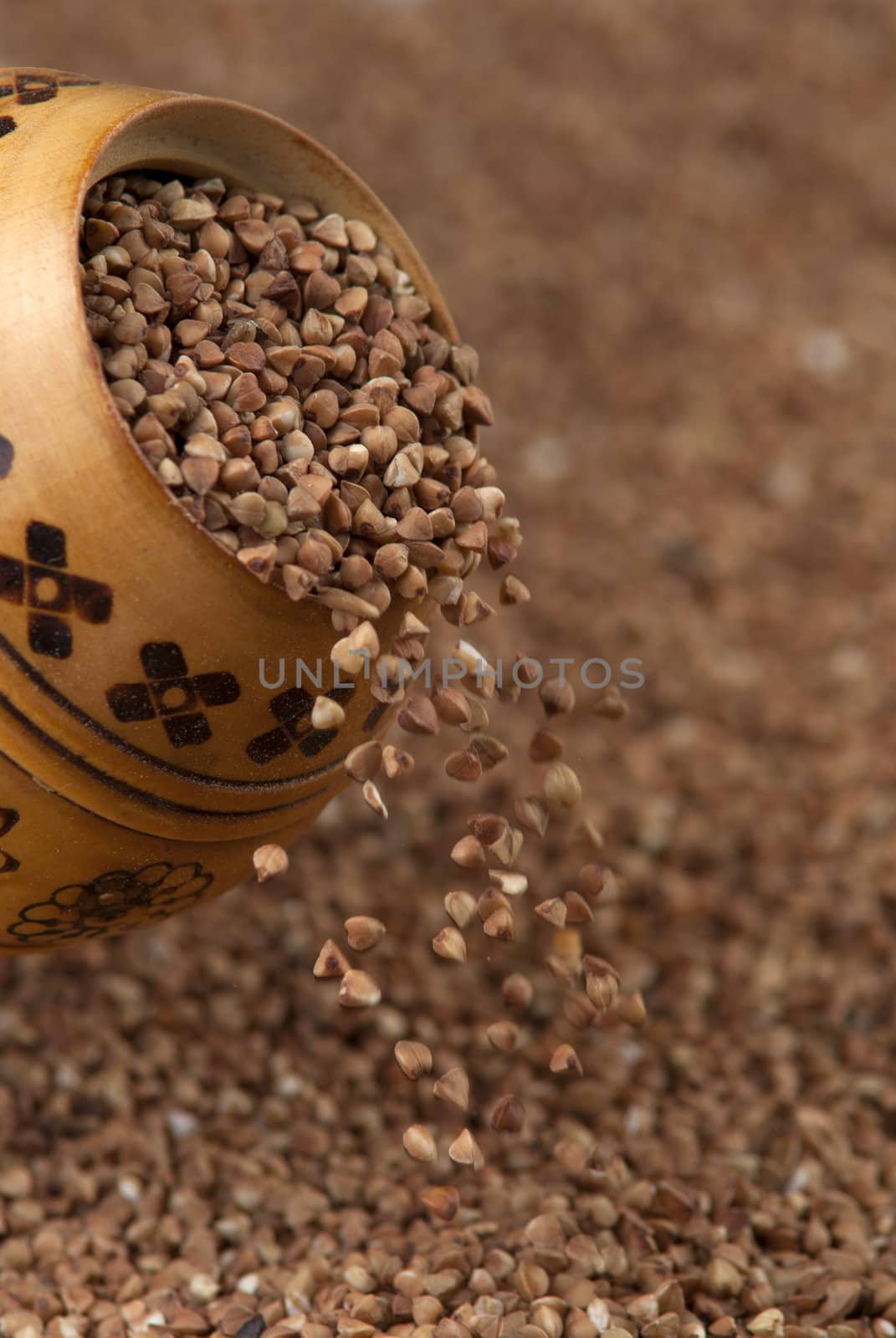 buckwheat falls from a wooden pot