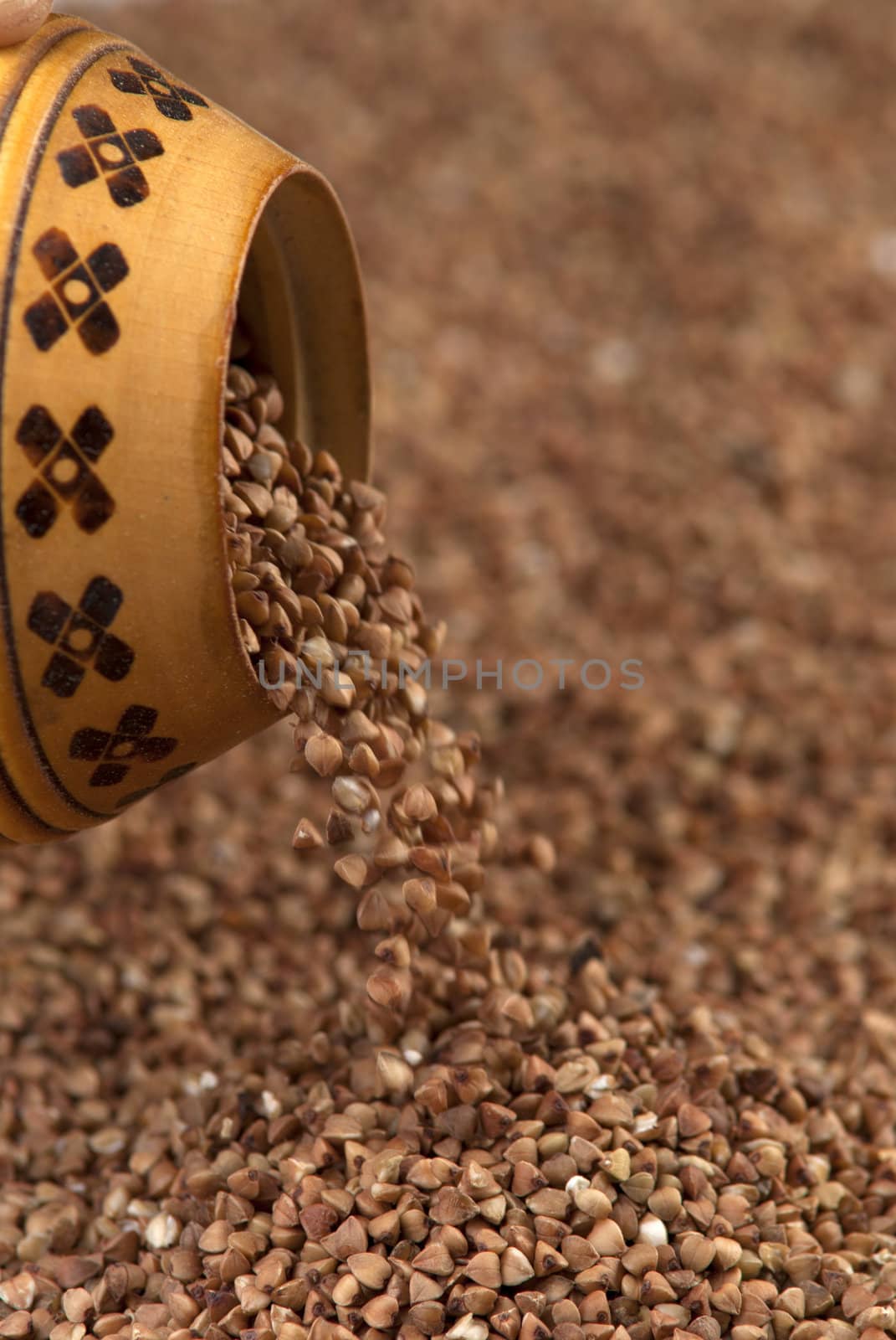 buckwheat falls from a wooden pot