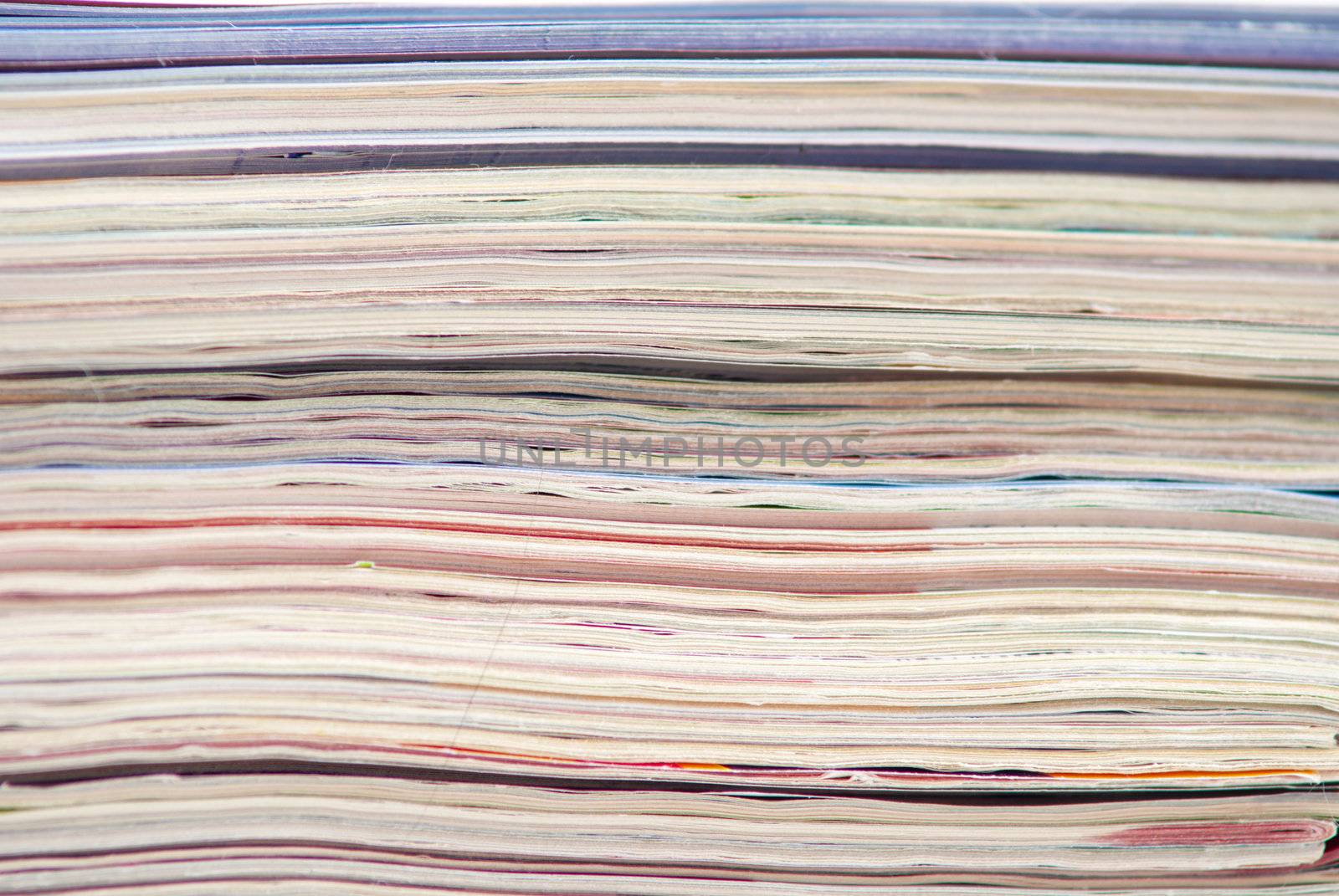 stack of colorful magazines or documents - paper edges background