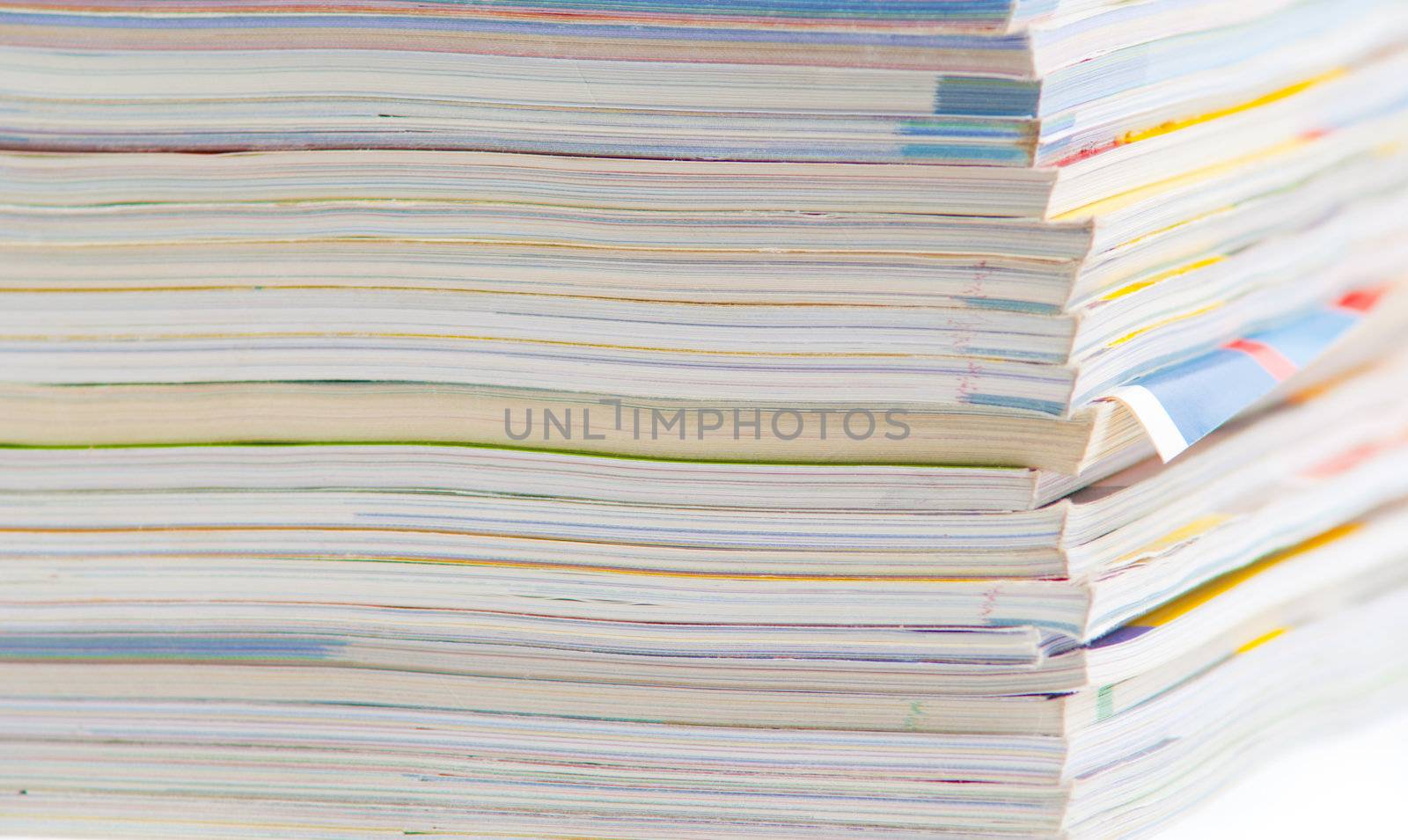 stack of colorful magazines or documents - paper edges background