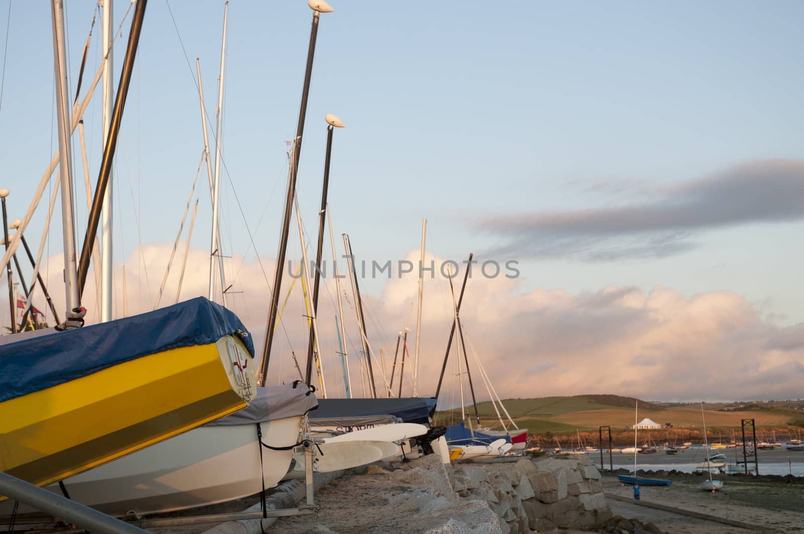Low angle shot of small boats hulls against evening sky, docked in Rock, Cornwall, UK