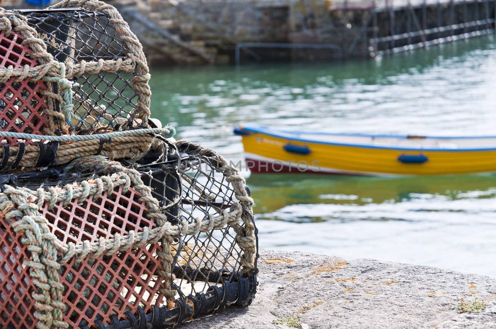 Detail of crab cages with small vessel in the background.