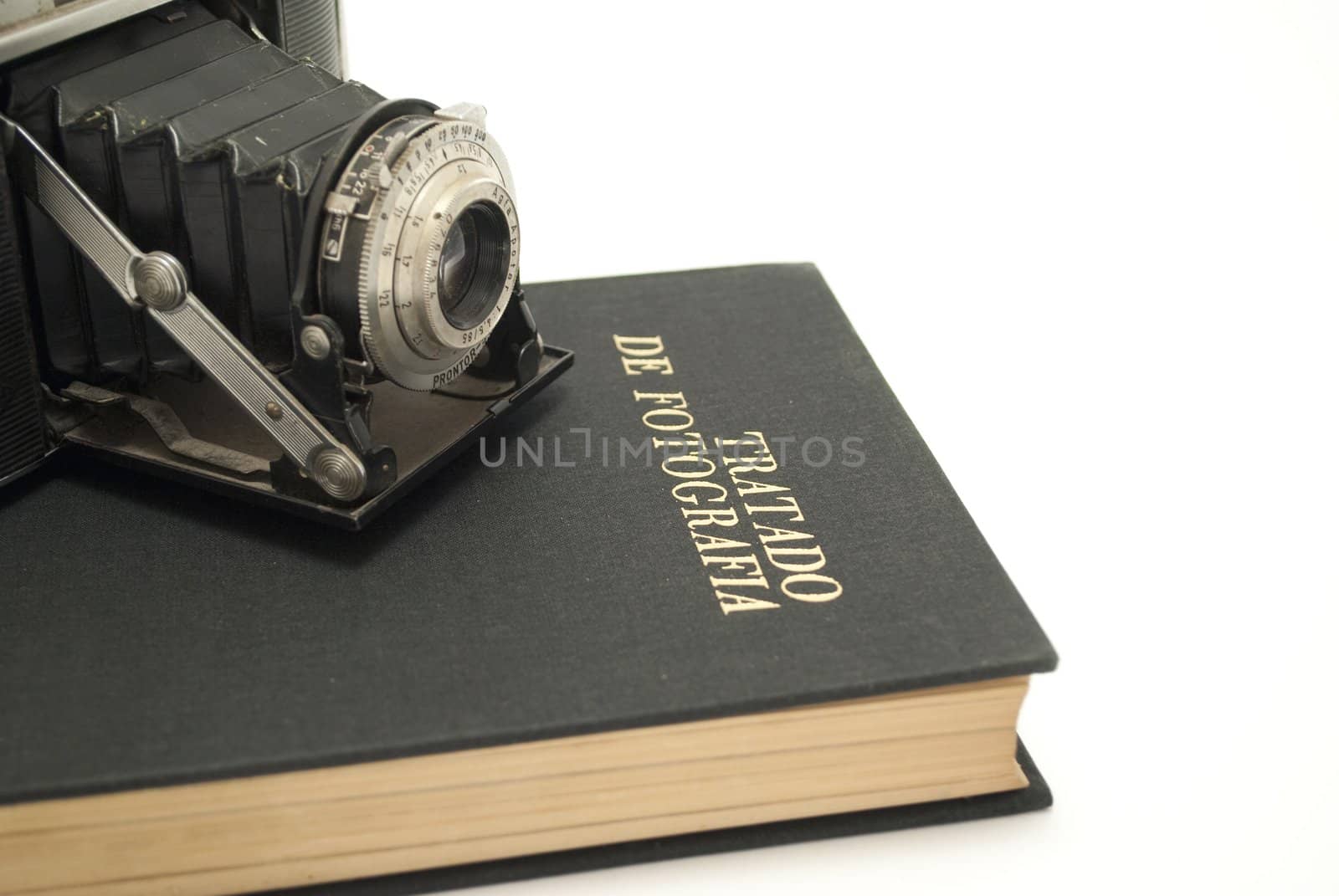 Old photo camera on book