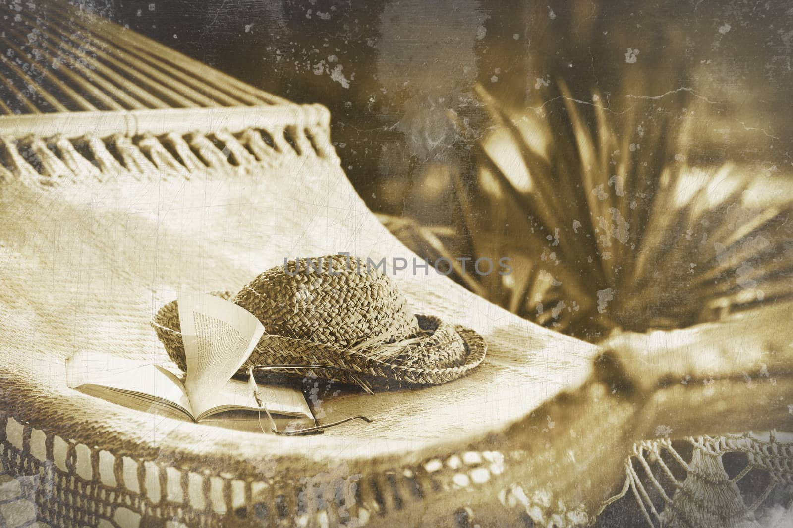 Old photo of hammock, book, hat, and glasses on a sunny summer day