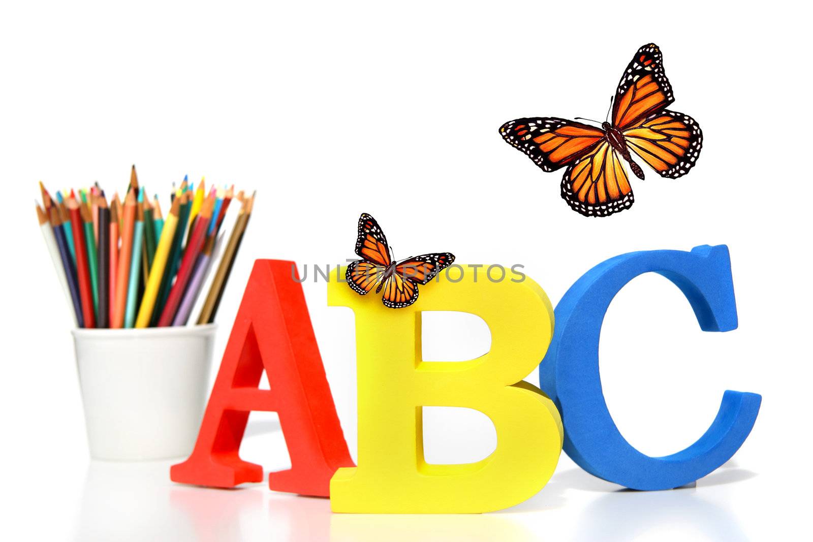 ABC letters with pencils on white background