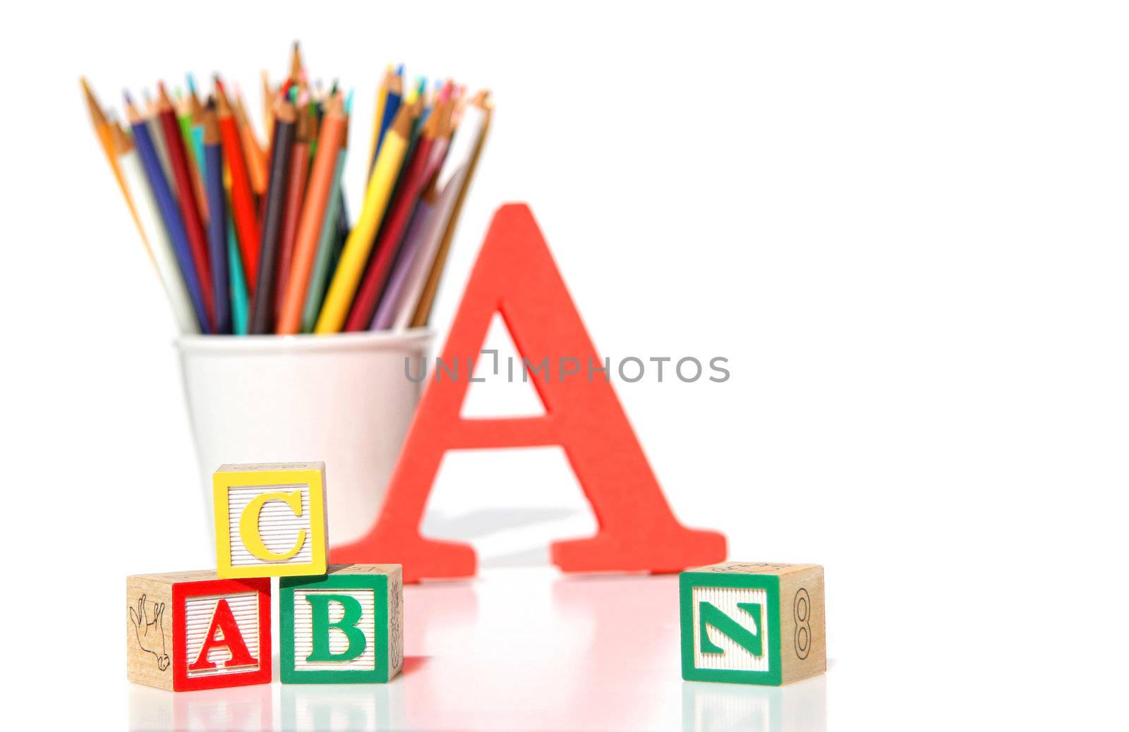 Wooden building blocks with pencils on white