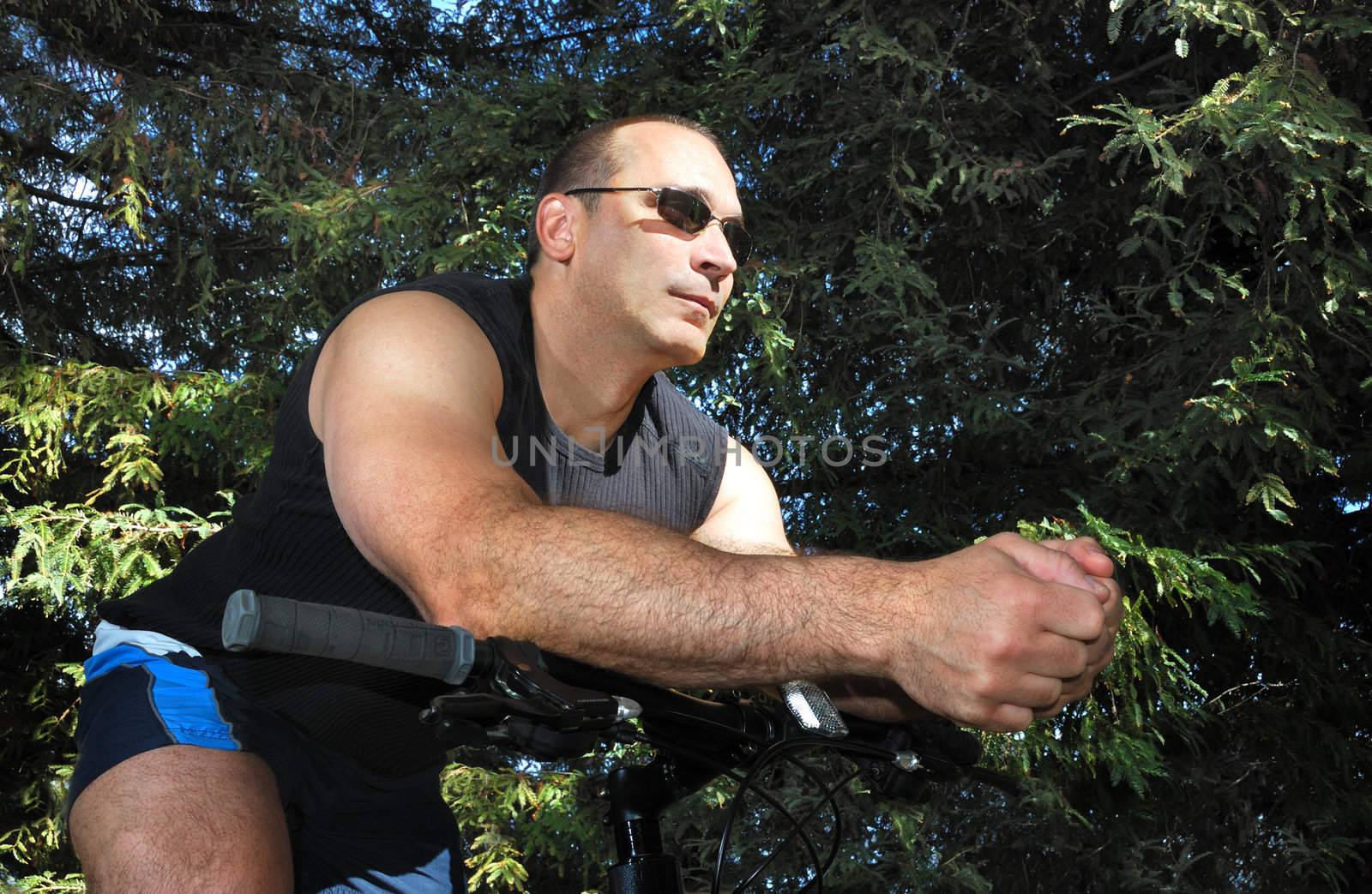 Man Riding a Bike in a Park on a Sunny Day