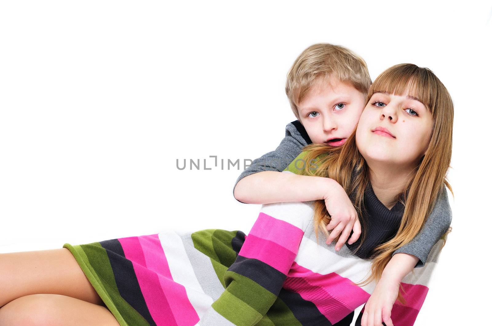 sweet sister and brother are laying on the white background