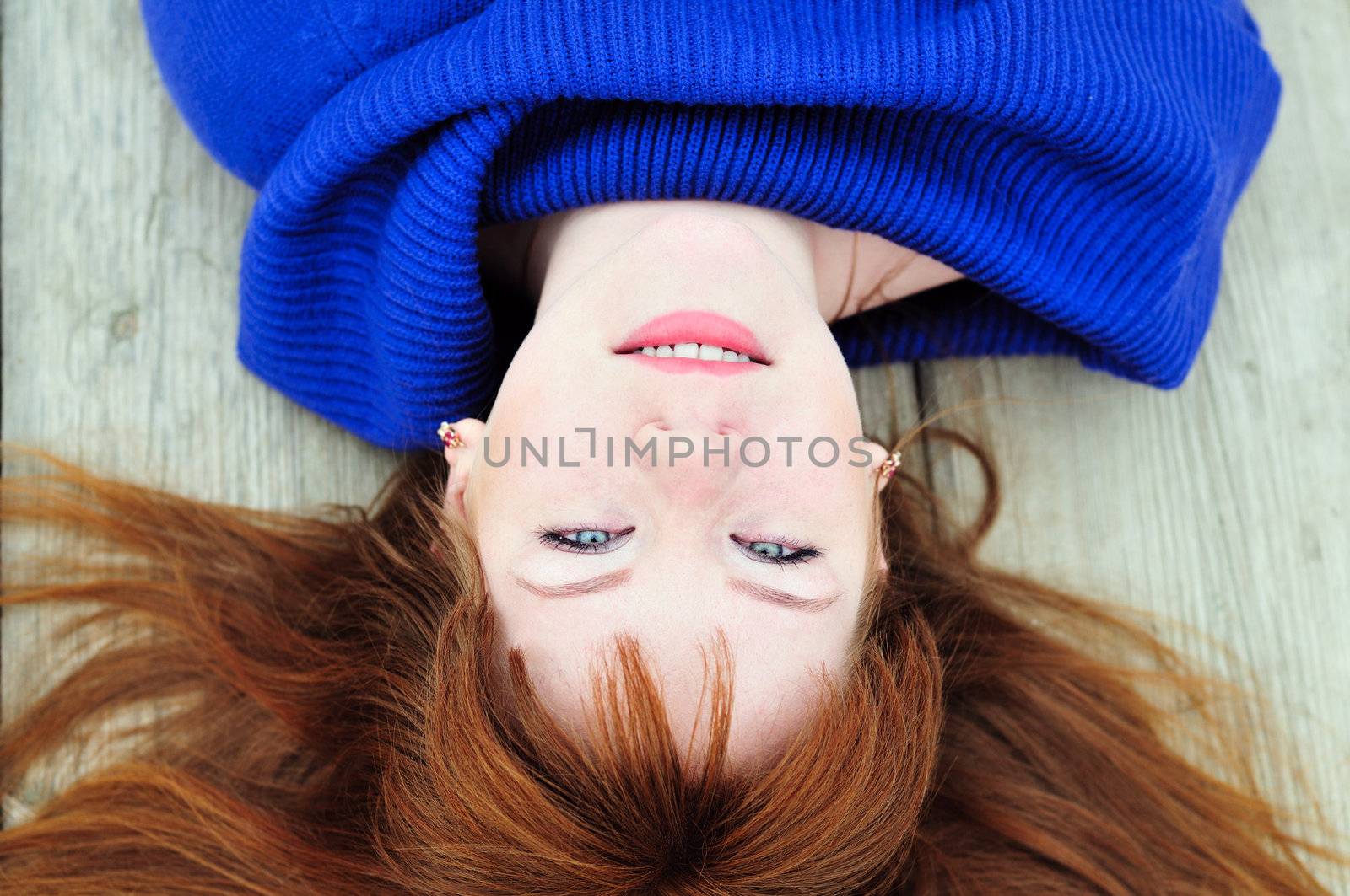 redheaded pretty  girl laying on the deck