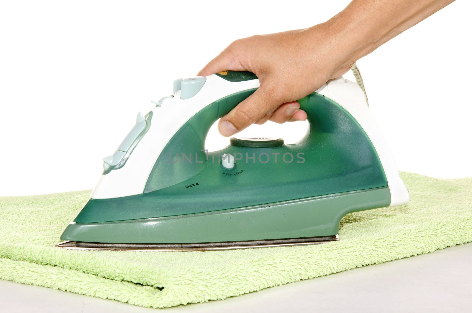 hand with an iron and ironing a towel on white background