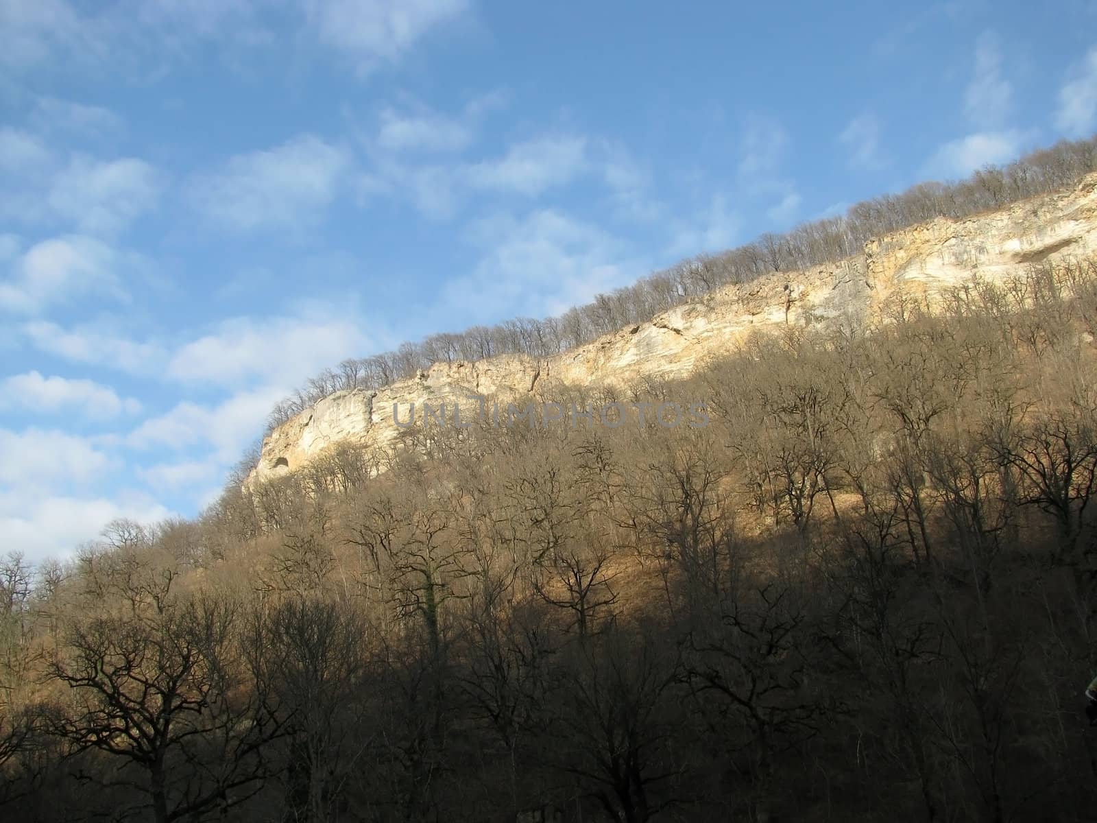 Clouds; rocks; a relief; a landscape; a hill