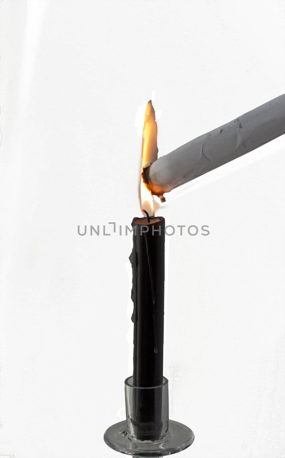 Black candle burning for destroying a white paper