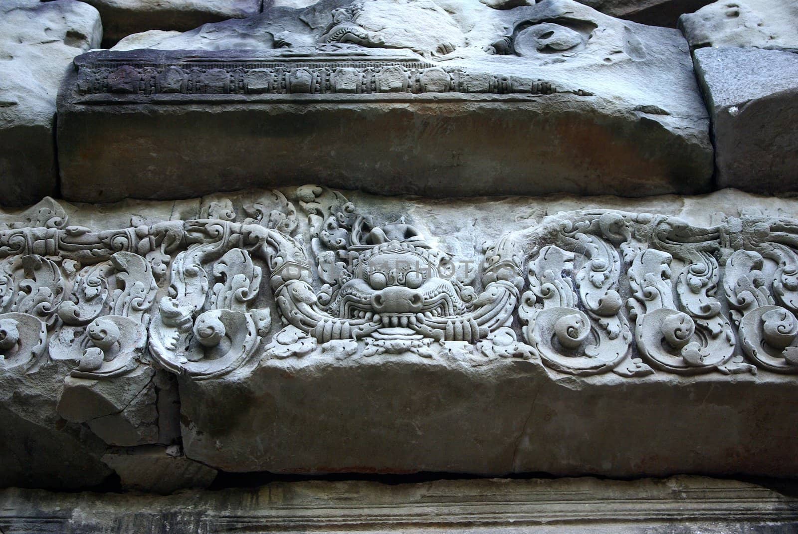 It's a close-up of an engraved grey stone of a temple in Angkor