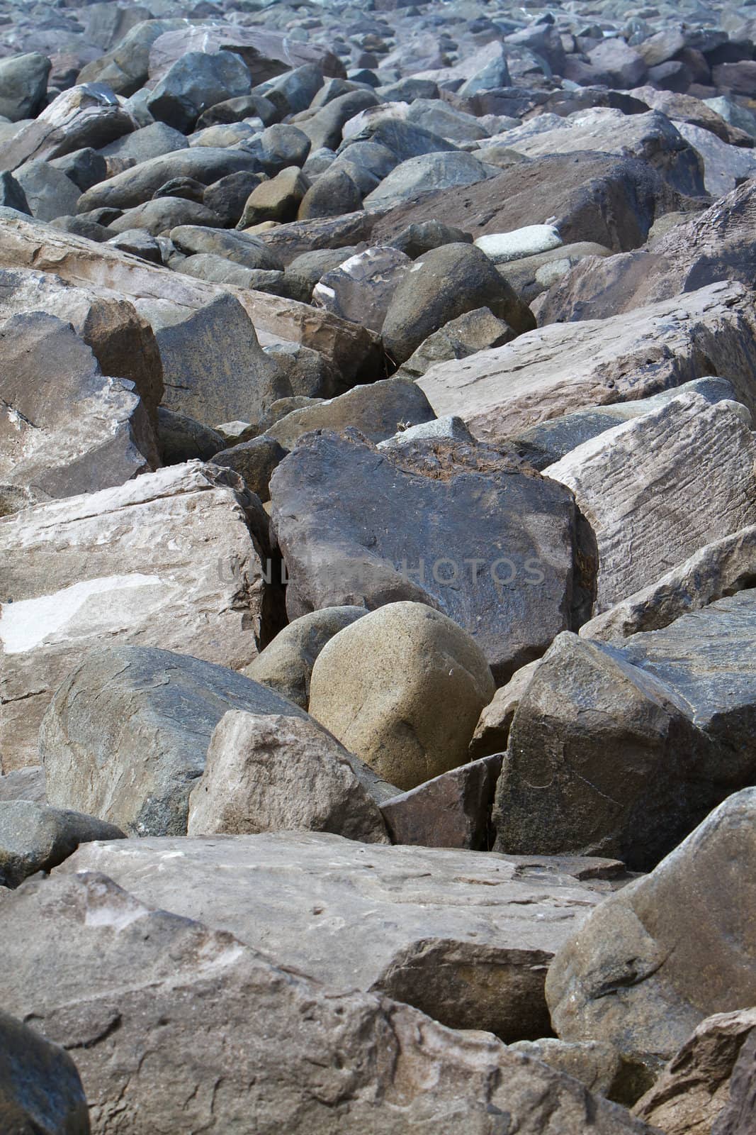 Jetty breaker boulders of large rocks to protect bay