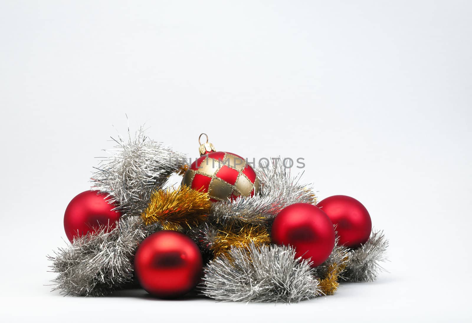 Christmas baubles in silver & gold tinsel on a white background