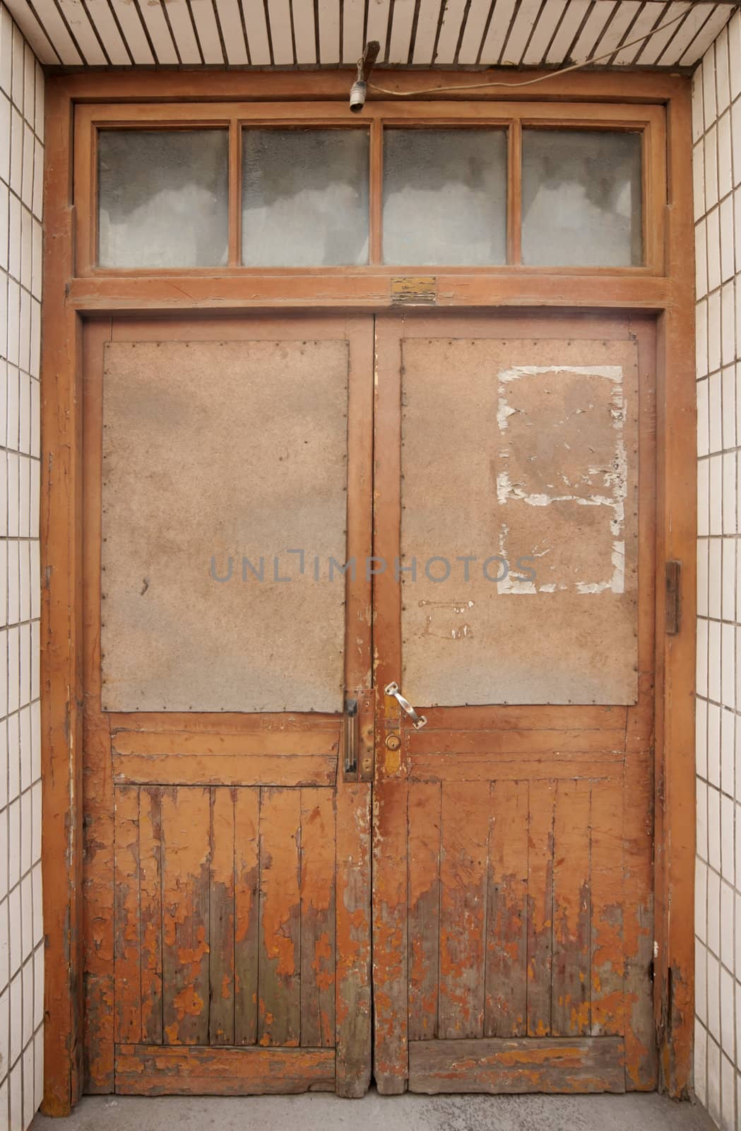 Tongli: boarded up wooden door. by Claudine