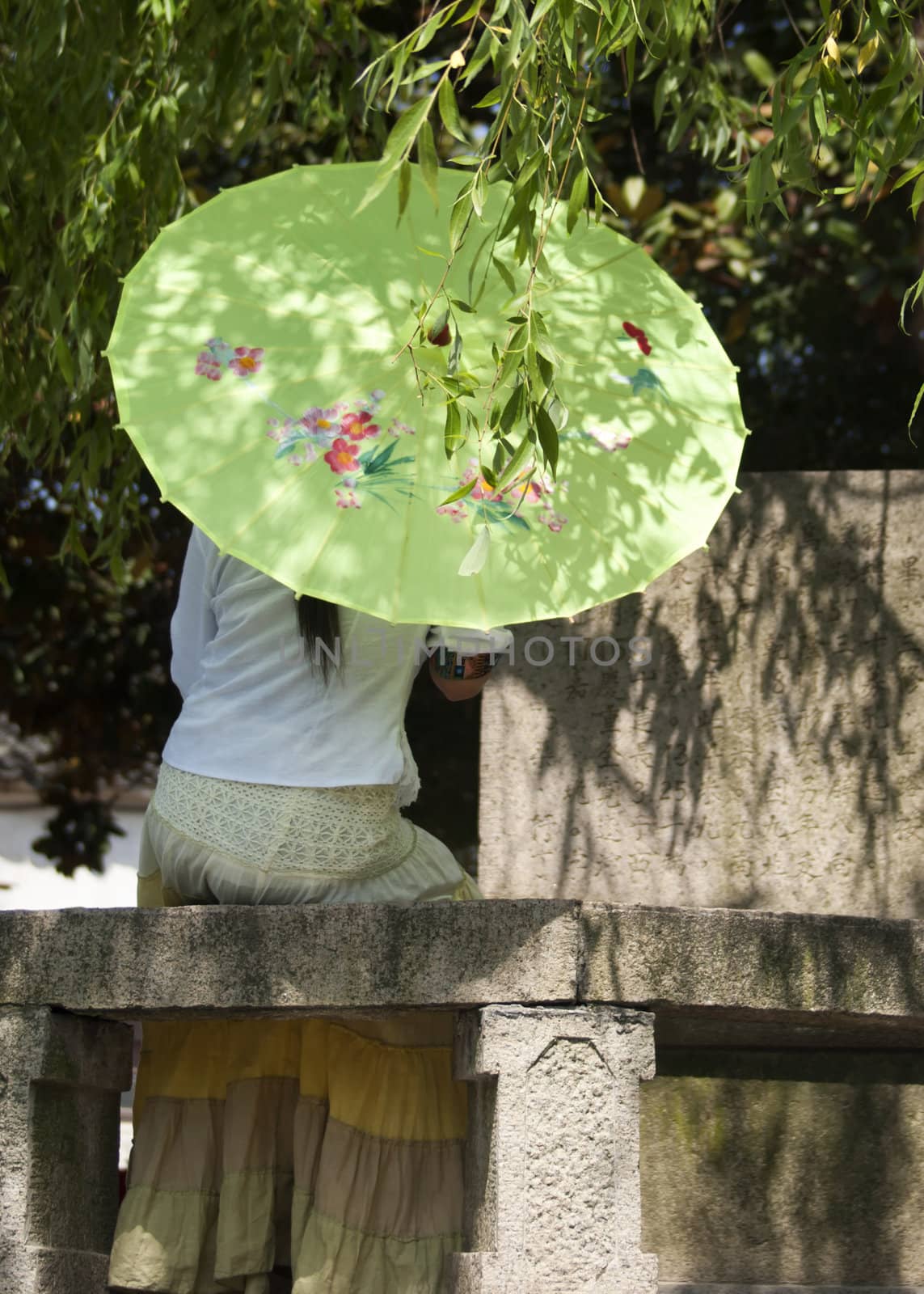 Tongli: lonely lady under umbrella caught in romantic thought. by Claudine