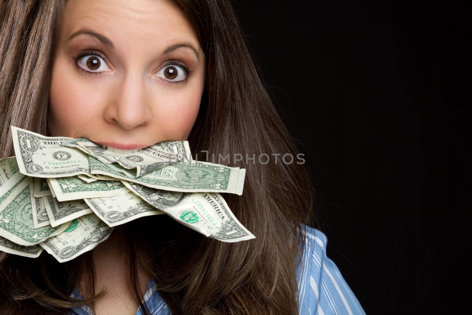Woman eating money in mouth
