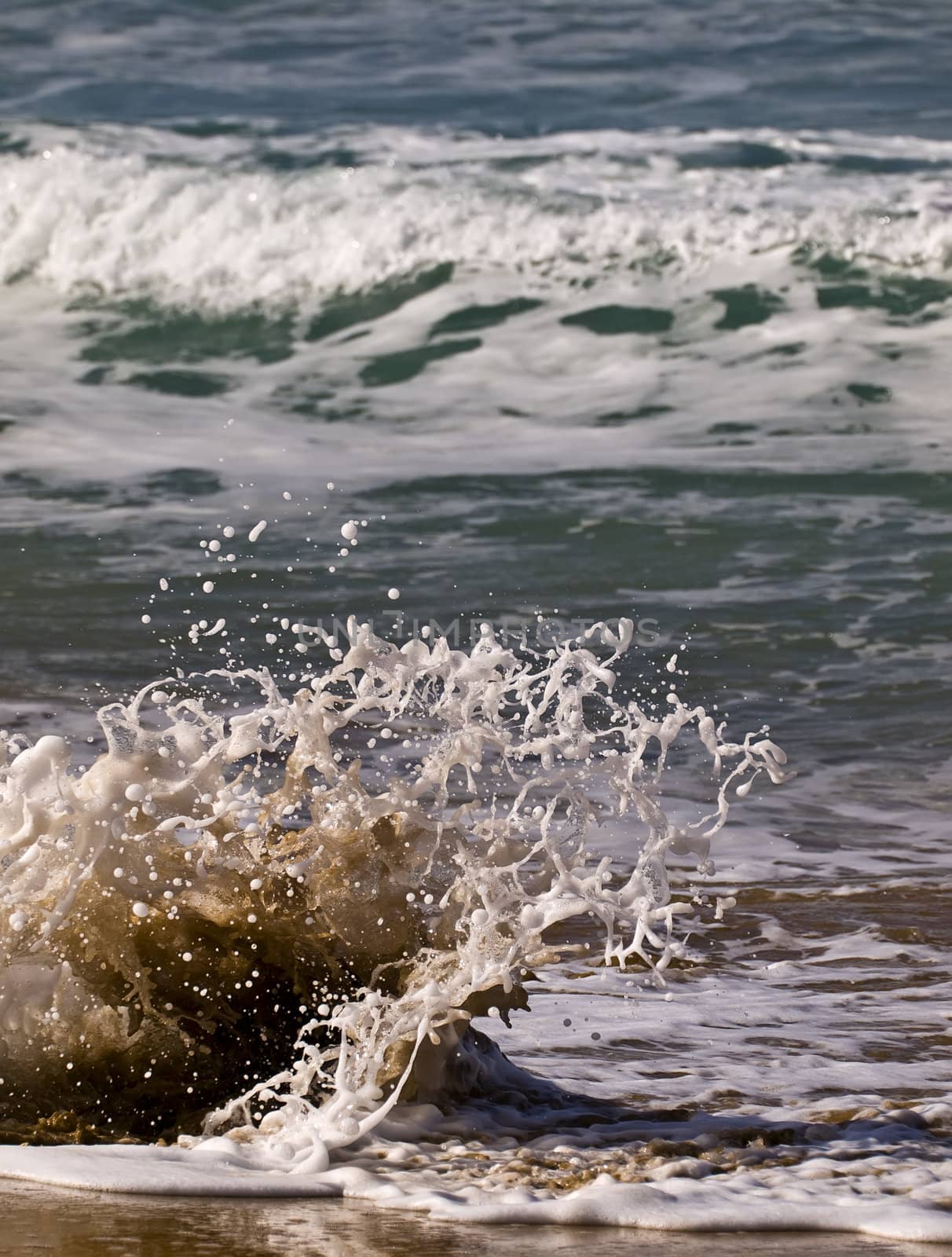 Waves crashing on the coast on a beach in Malta