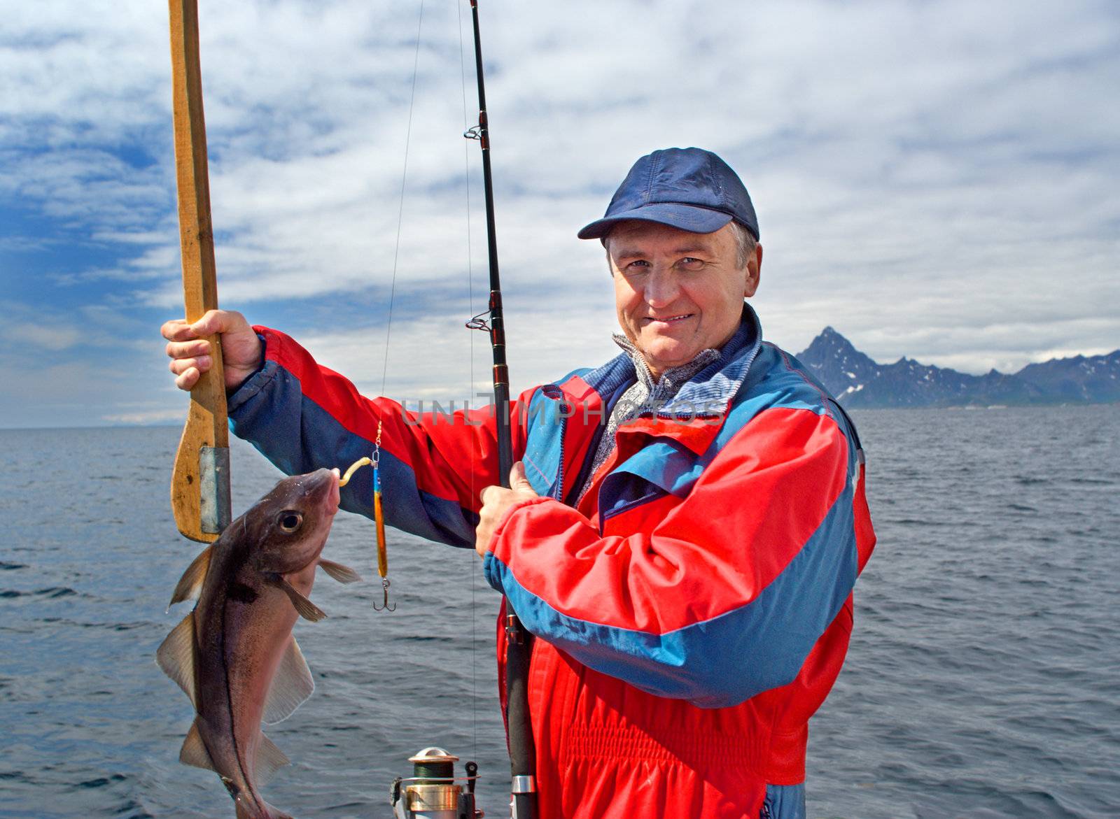 Fisherman with a fish on the Lofoten island