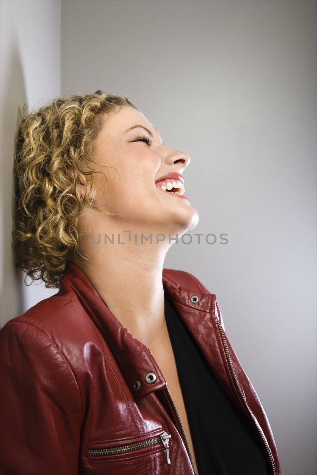 Blond woman laughing. by iofoto