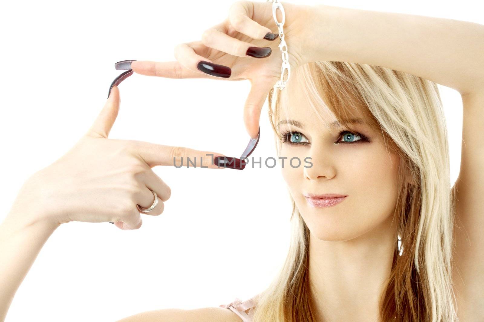 blond with long nails looking through her fingers in a box shape