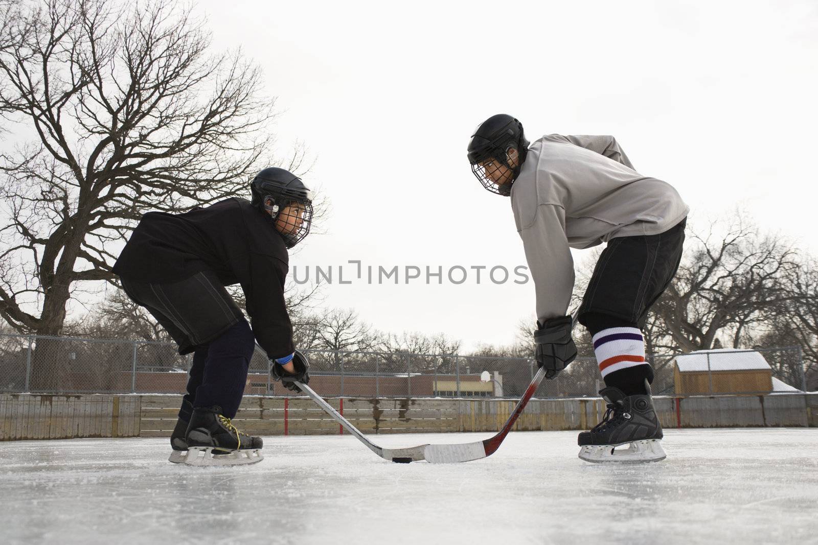 Hockey player face off. by iofoto