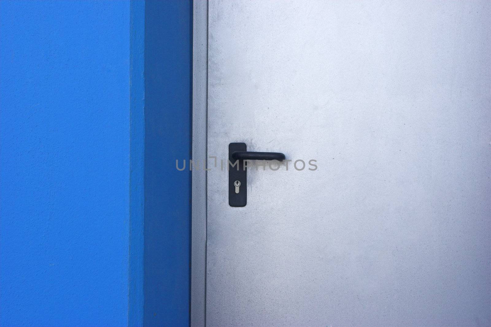 Picture of a door in a modern building with blue walls