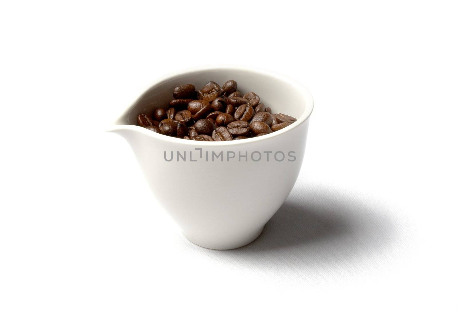 cup full of colombian coffee beans by dolgachov
