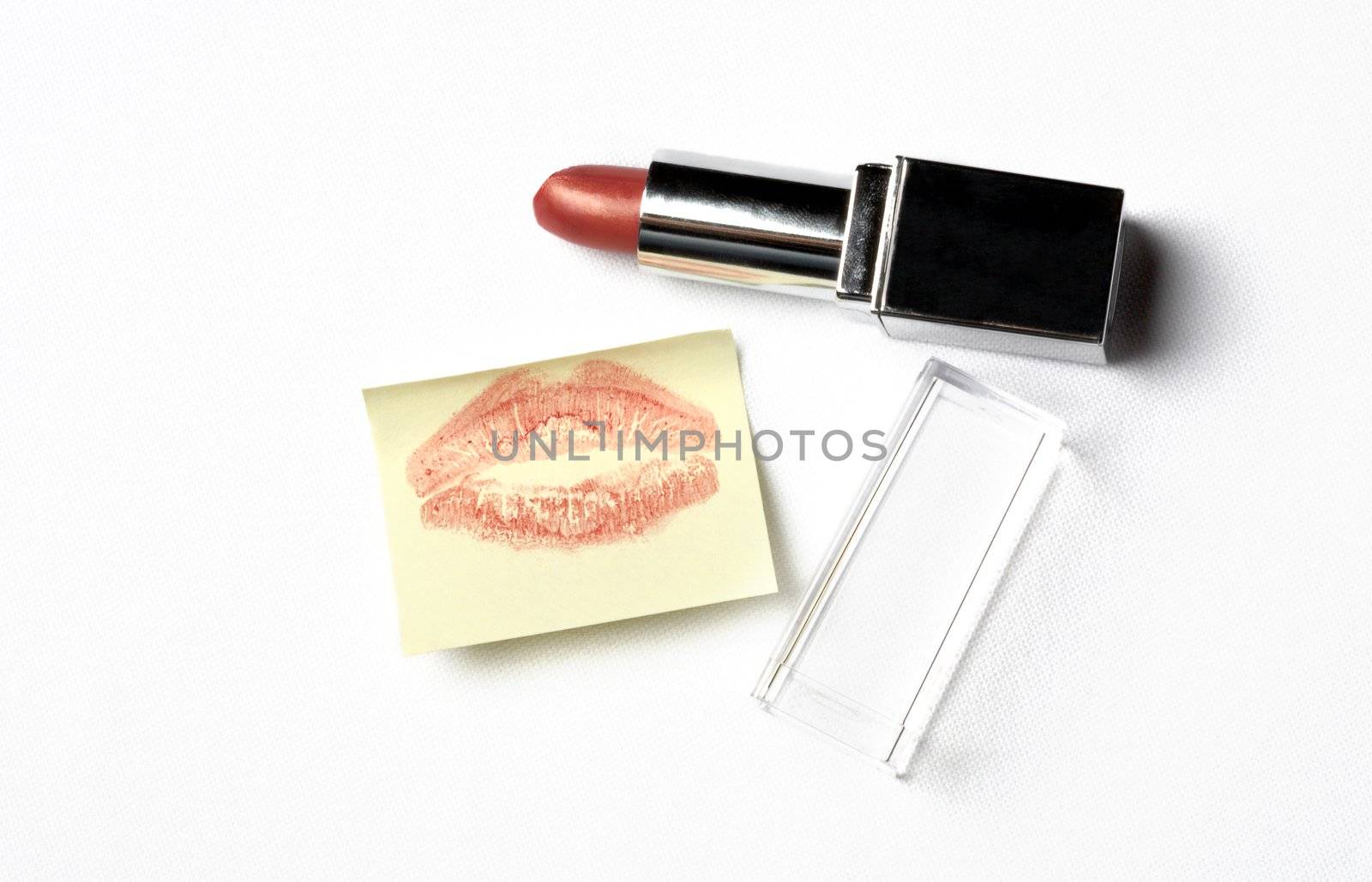 red lipstick and yellow sticker note with kiss by dolgachov