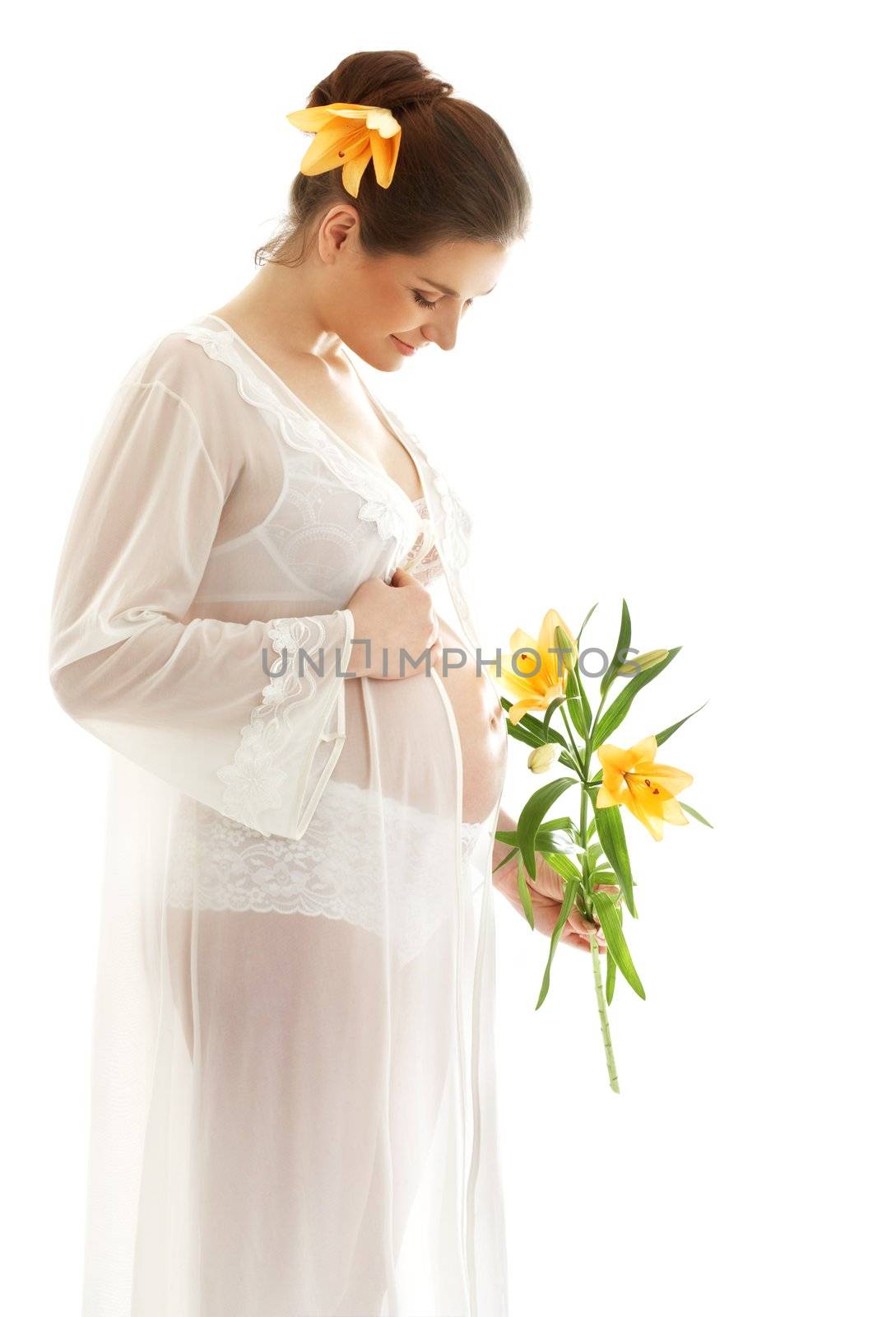 beautiful pregnant woman with yellow lily over white