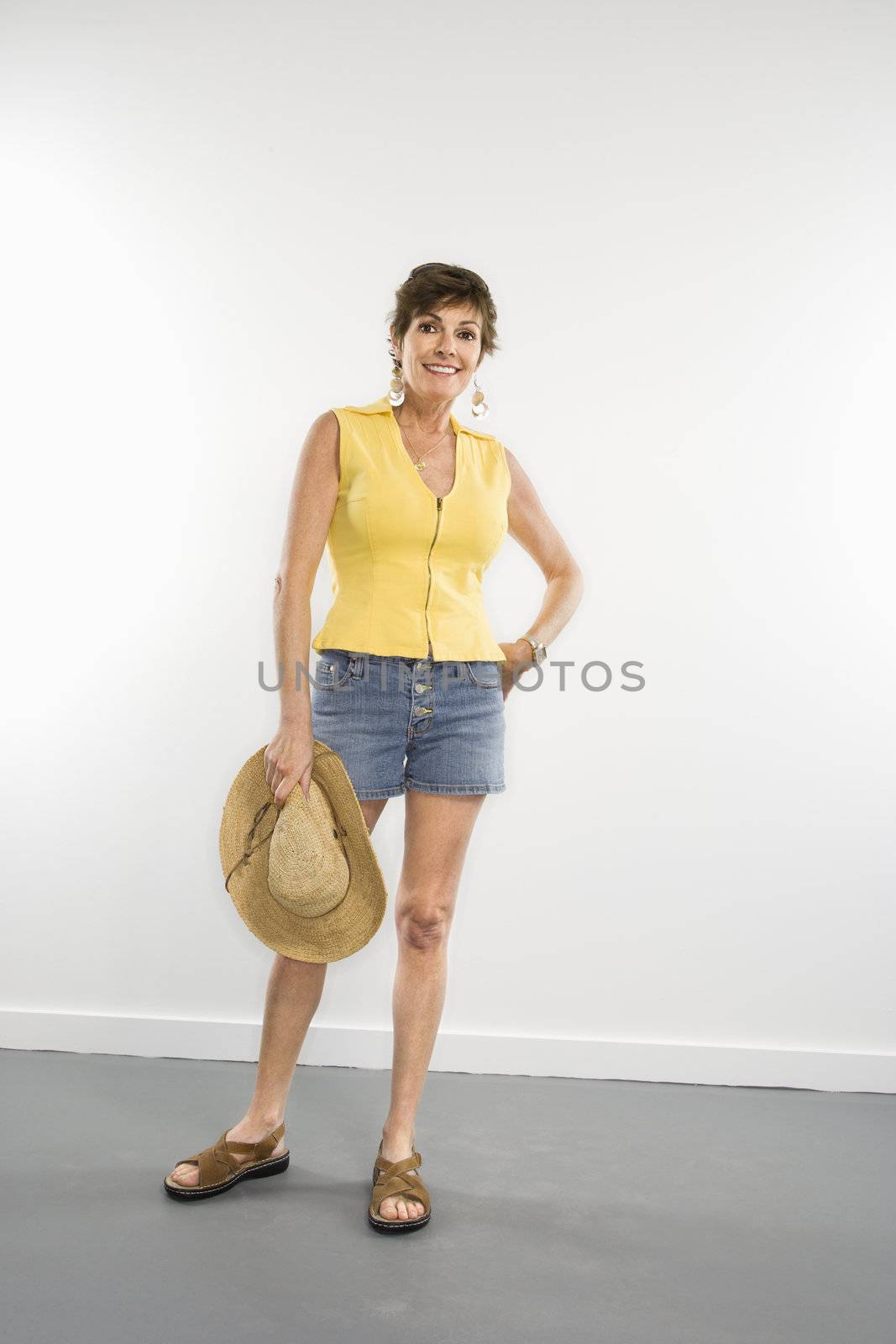 Portrait of pretty Caucasian woman in summer attire smiling.