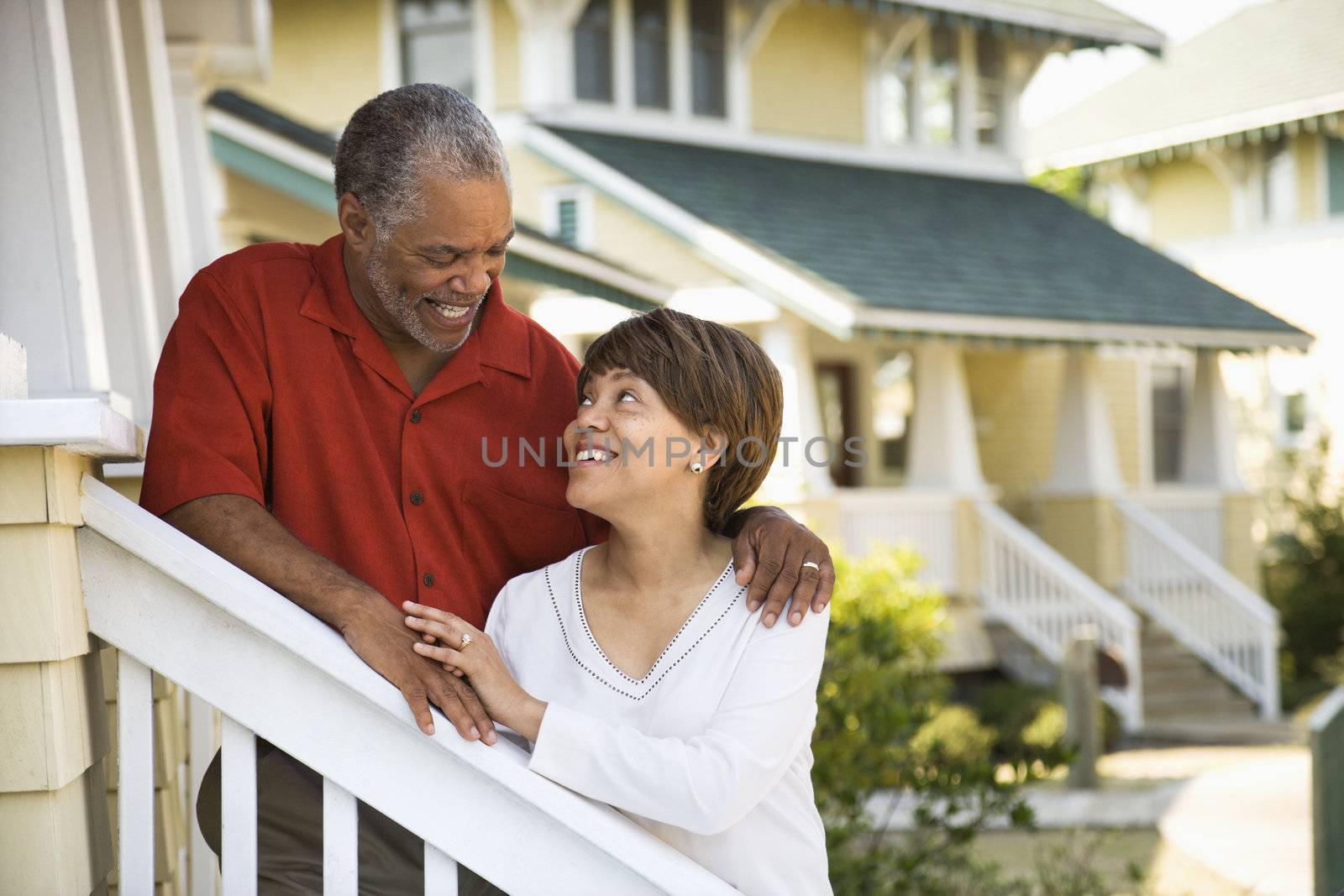 African American middle aged couple smiling at each other.