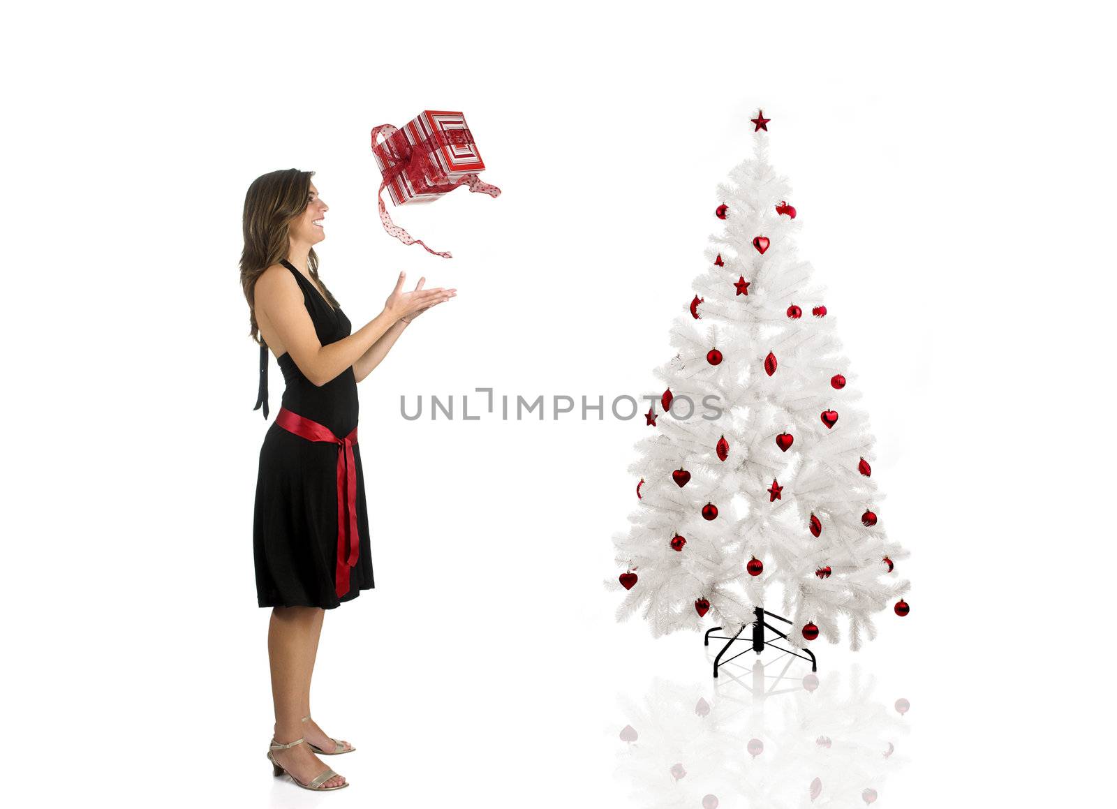 Beautiful Woman wiht a gift and a Christmas tree