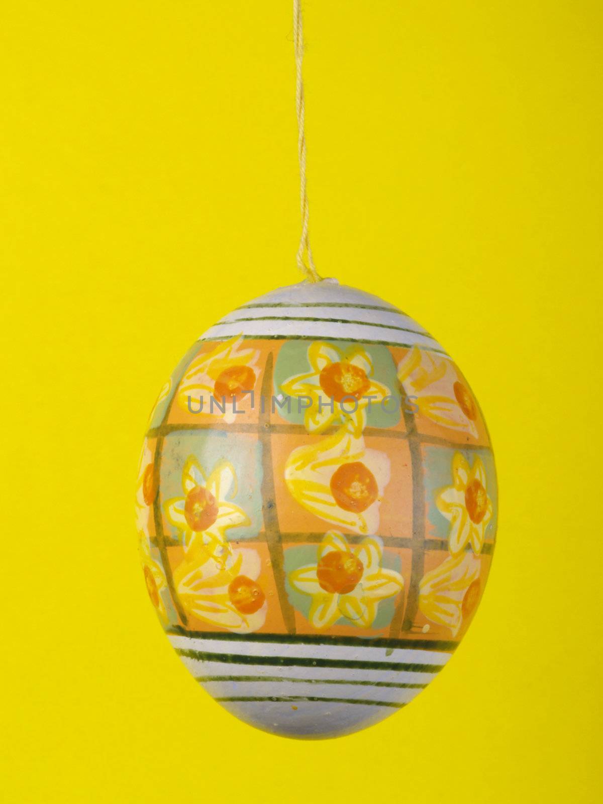 handpainted easter egg over yellow