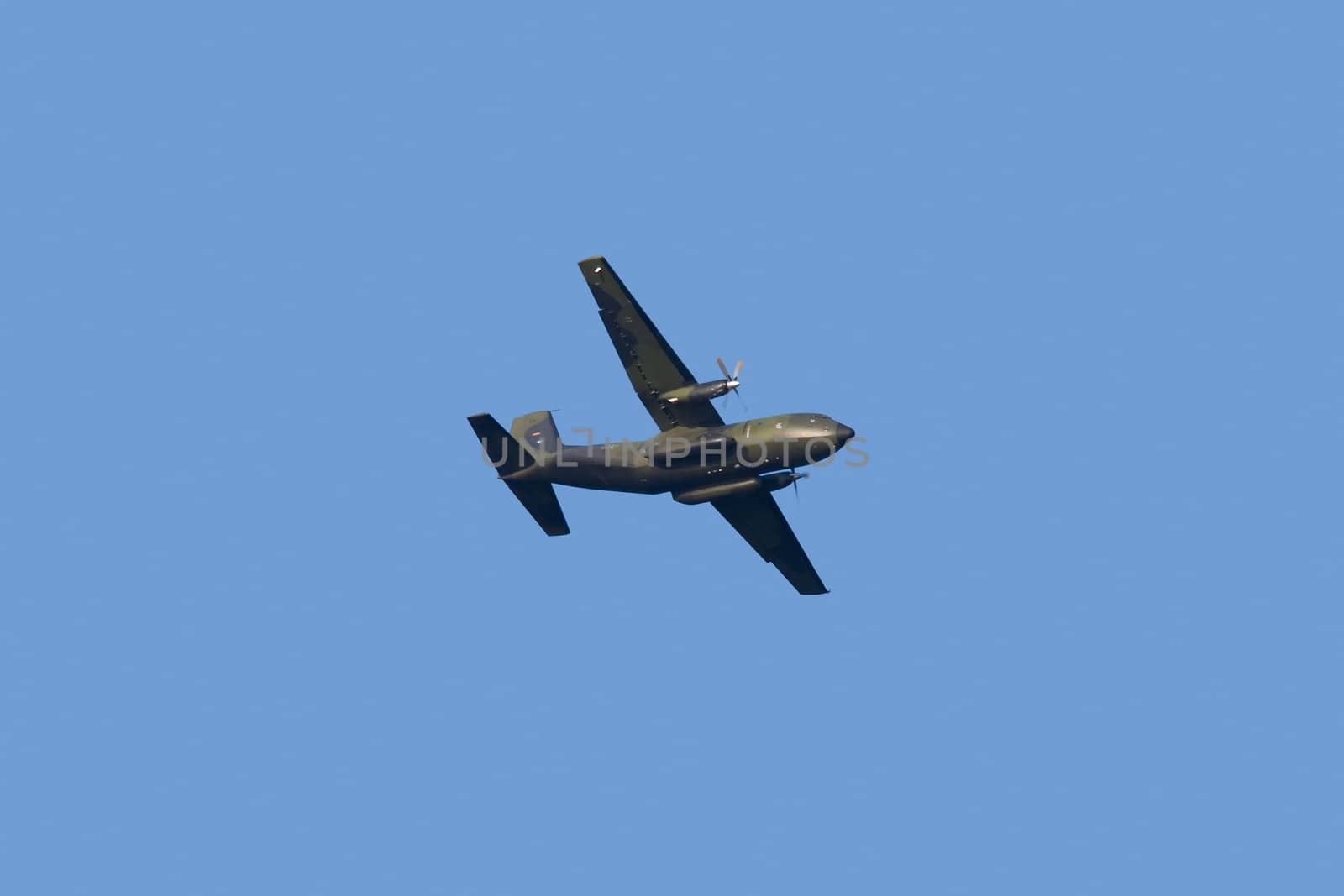 Military propeller aircraft flying in a clear skies