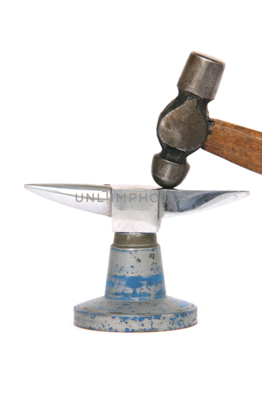 tiny inox anvil and small hammer detail isolated on white background