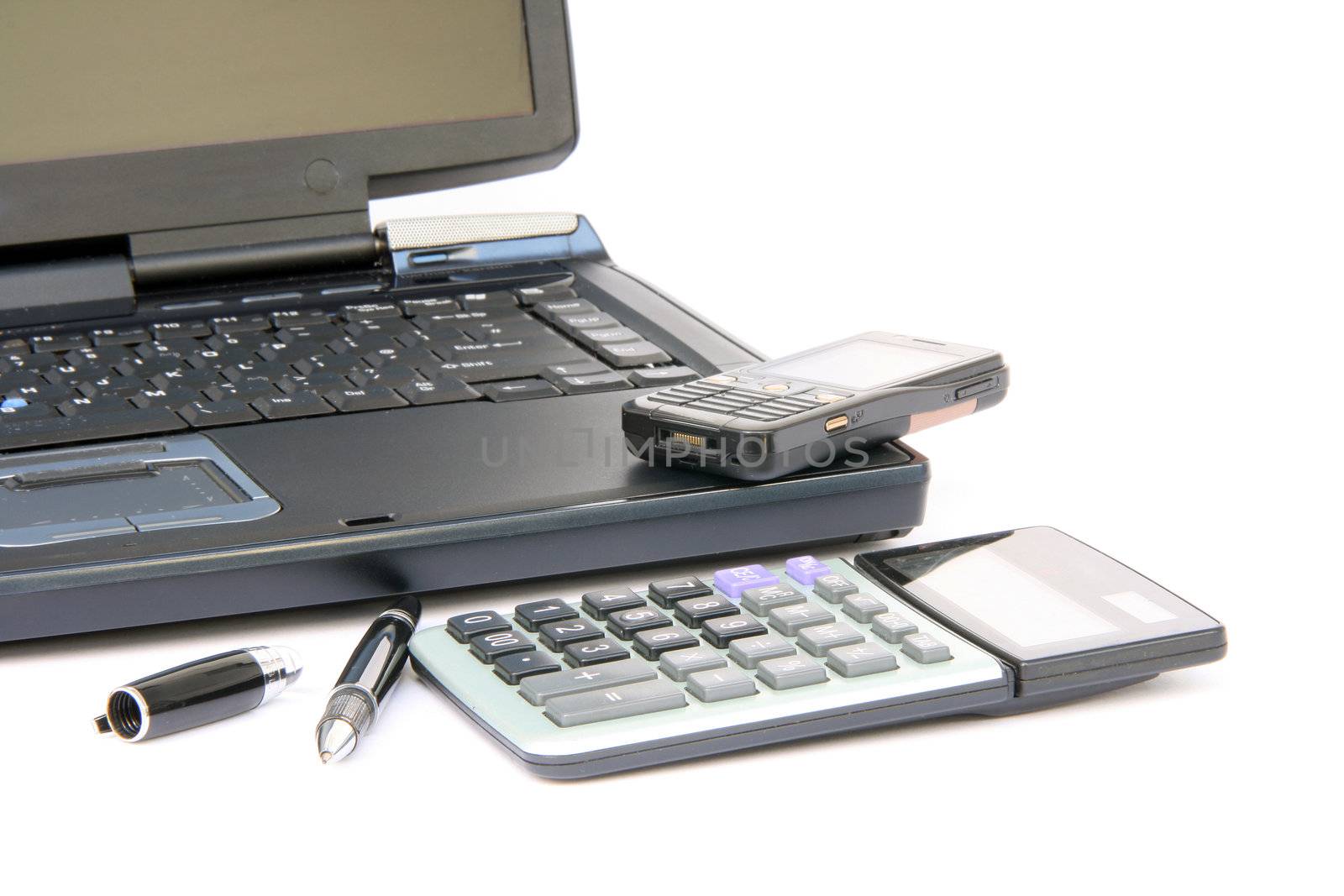 laptop detail with pen cellphone and calculator isolated on white background