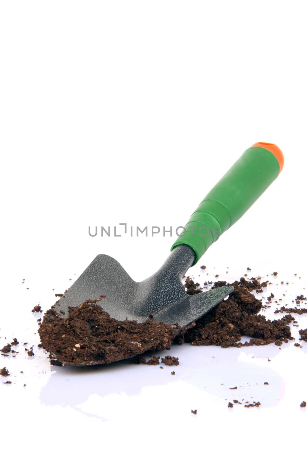 garden tools shovel and soil on white background