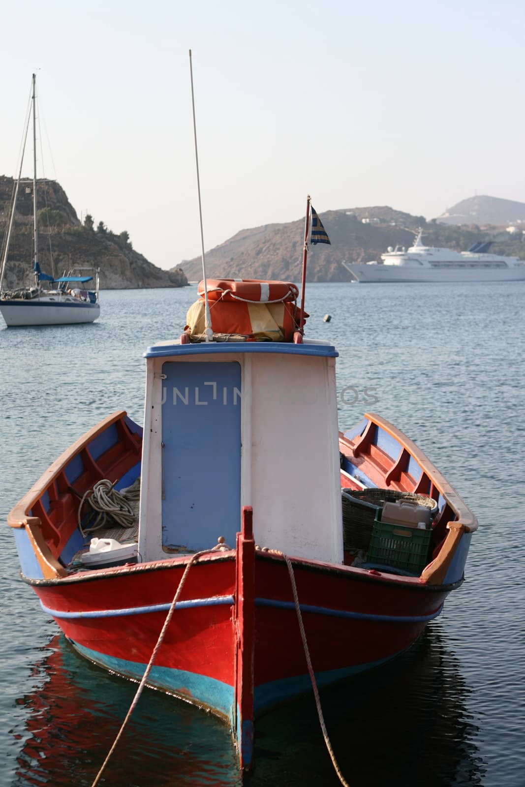 small boat yacht and cruise ship moored at patmos island greece