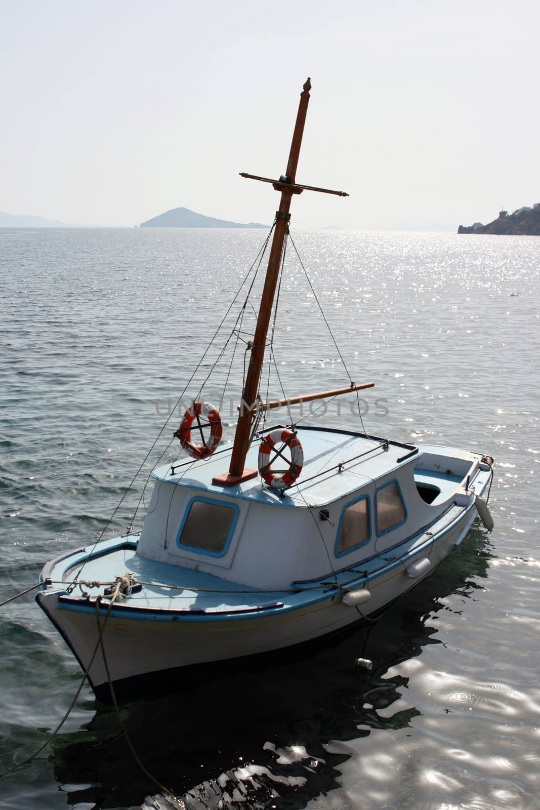colorful traditional greek small wooden fishing boat moored